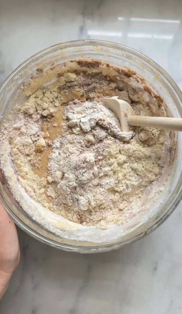 Fold the dry ingredients to the bowl of the Protein Cottage Cheese Banana Muffins batter.