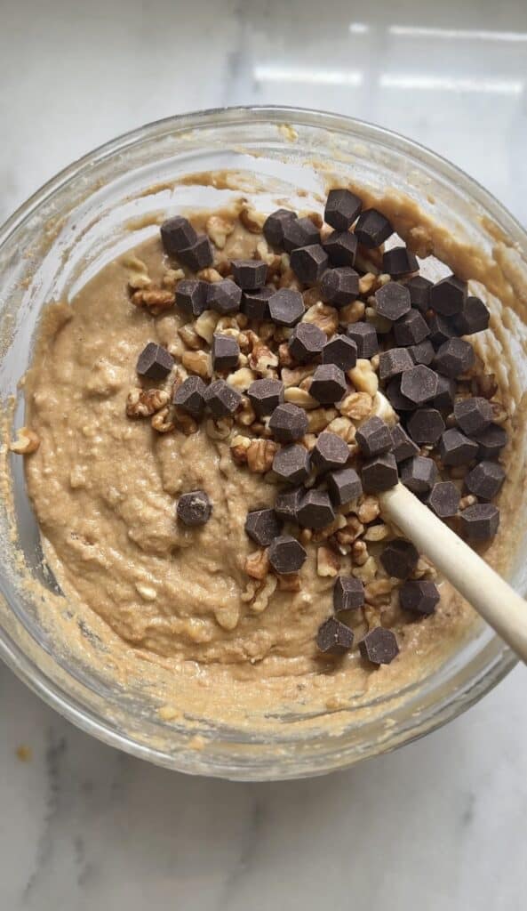 Fold the chocolate chips and nuts in the Protein Cottage Cheese Banana Muffins batter.