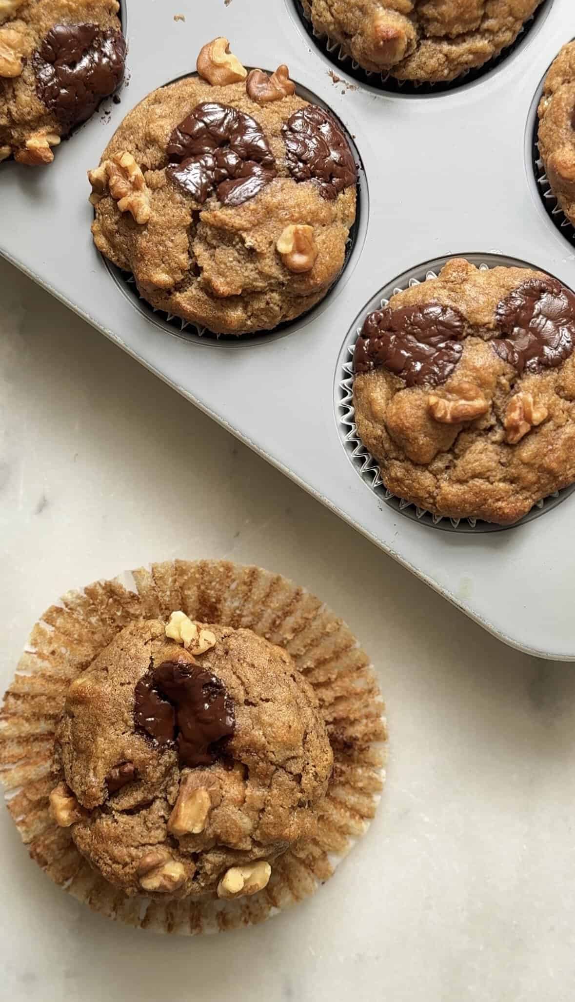 One of the Protein Cottage Cheese Banana Muffins unwrapped to show texture.