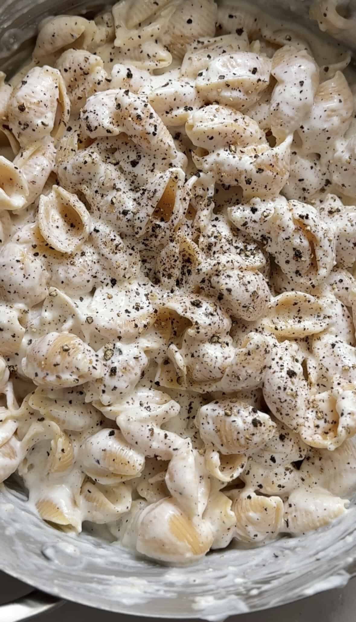 Finished cacio e pepe mac and cheese with fresh cracked black pepper on top.