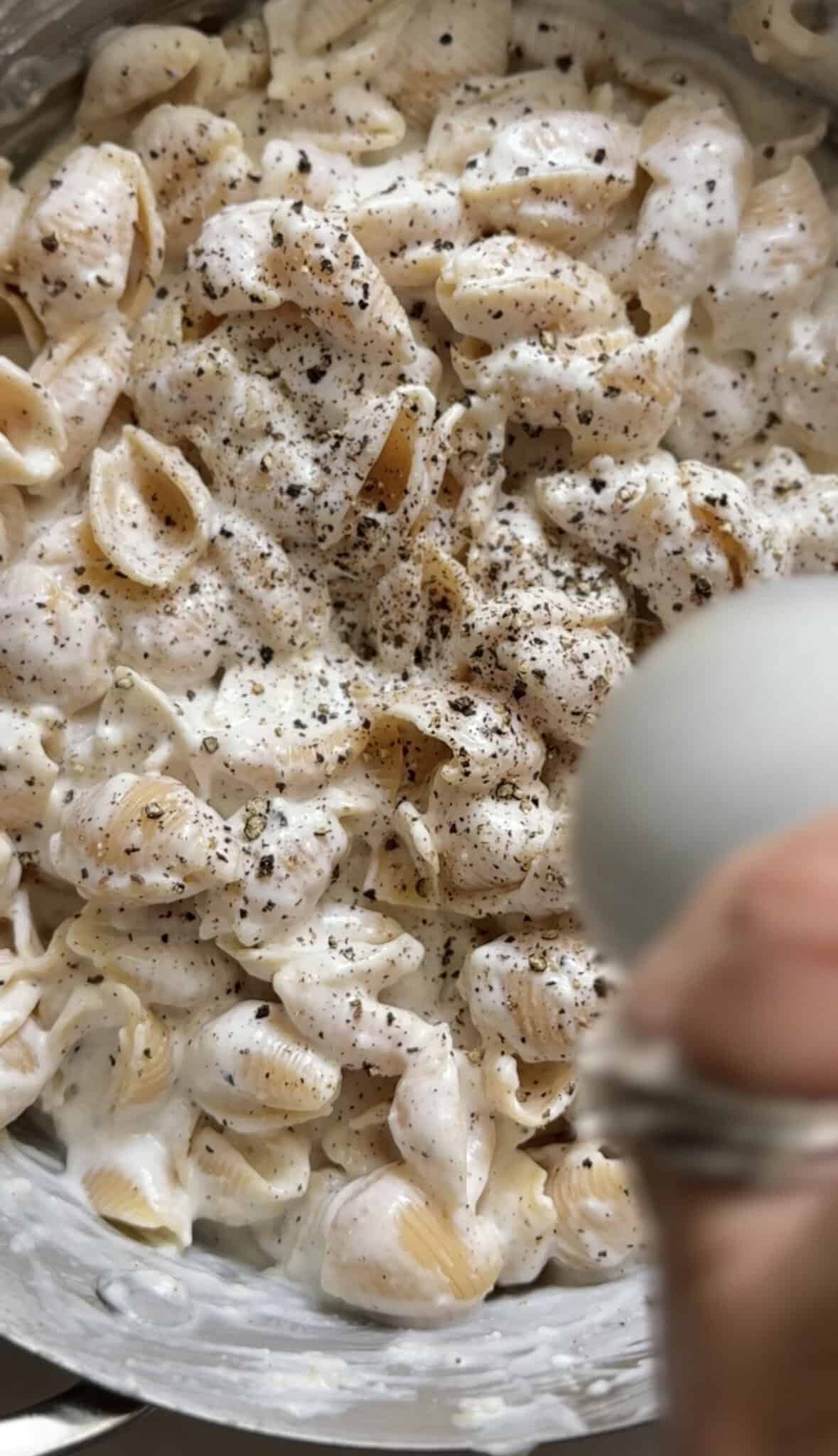 Add fresh cracked black pepper on top of the cacio e pepe mac & cheese.