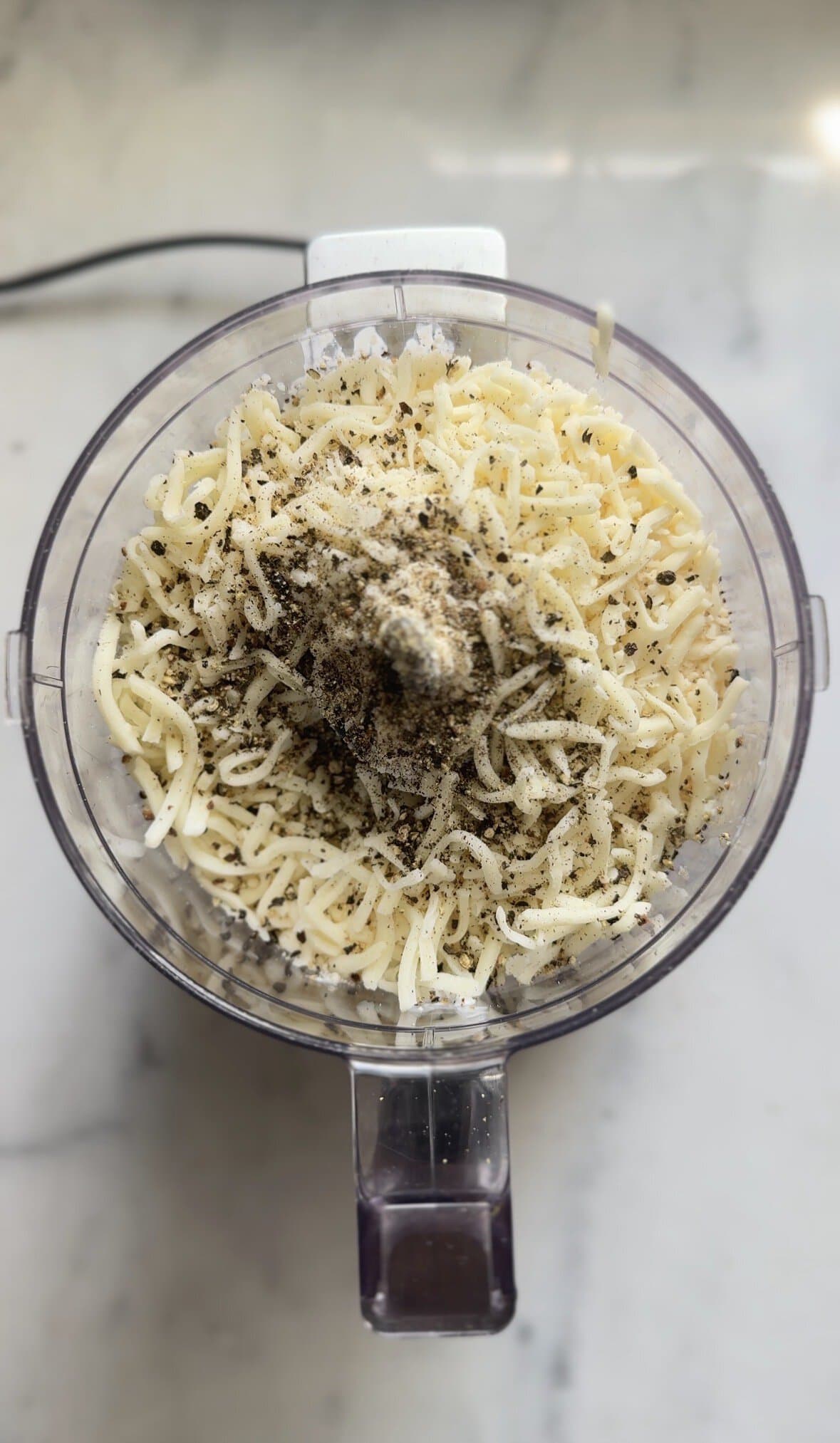Part 2 of adding the cacio e pepe mac and cheese sauce ingredients in the food processor bowl.