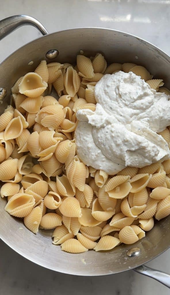Add the Cacio e pepe cottage Cheese Mac & Cheese sauce into the protein pasta.