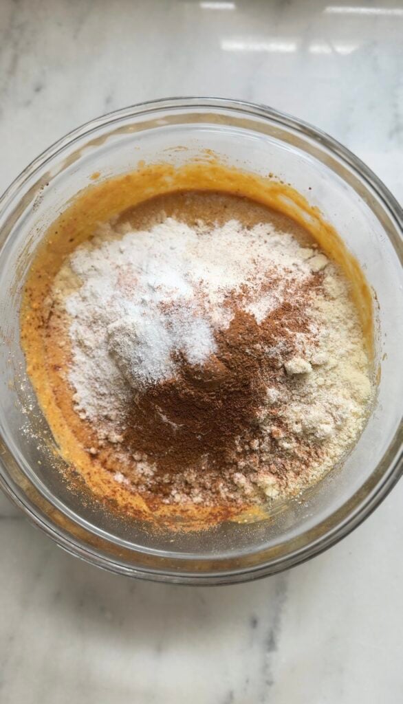 Add dry ingredients to the wet ingredients in the bowl.