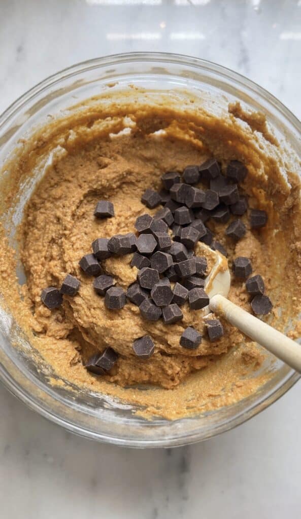 Add chocolate chips to the Gluten Free Protein Pumpkin Bread batter.