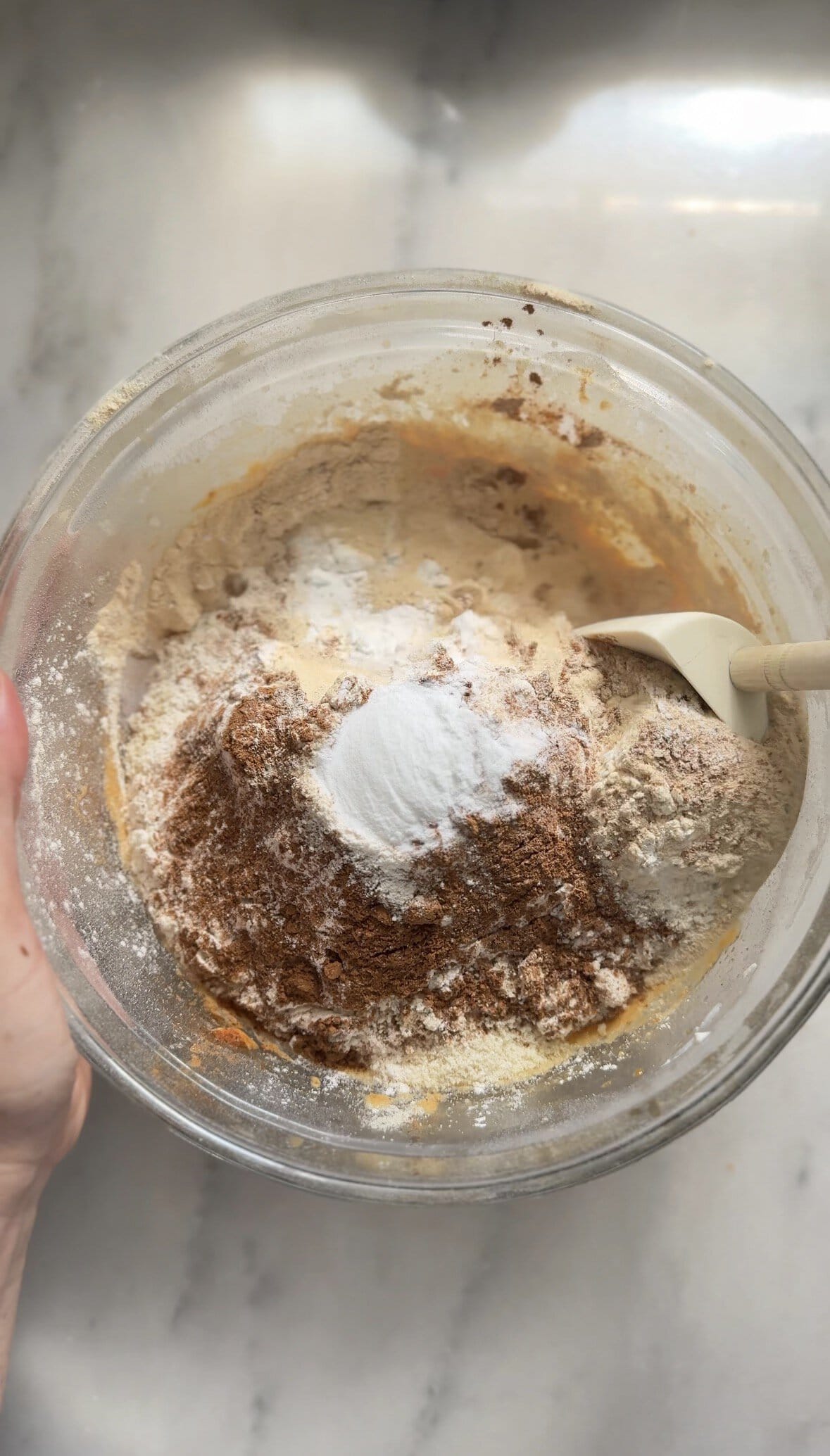 Start folding the dry ingredients to the wet ingredients of the pumpkin cottage cheese muffins into the same bowl.