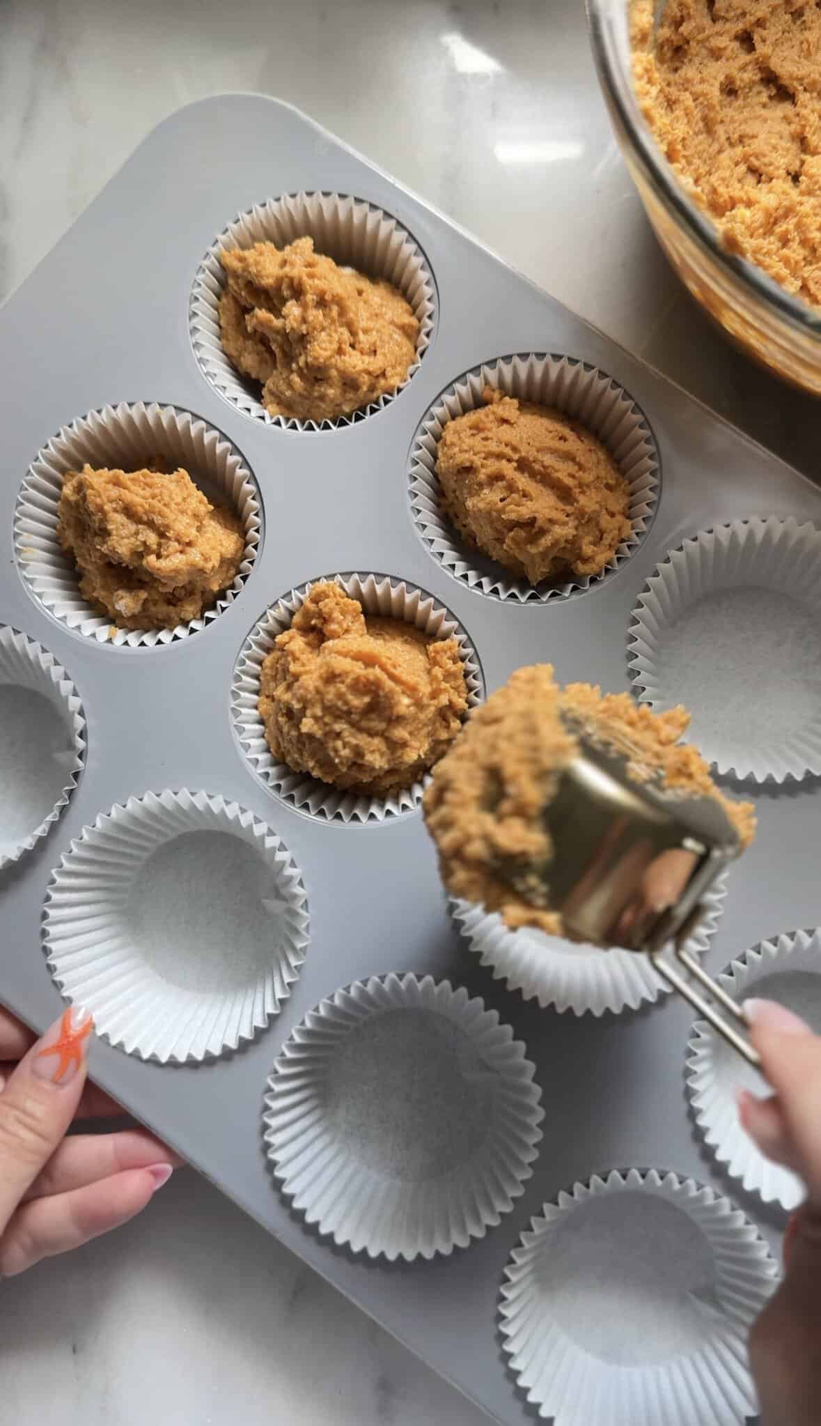 Scoop the pumpkin cottage cheese muffins into the muffin liners completely full.