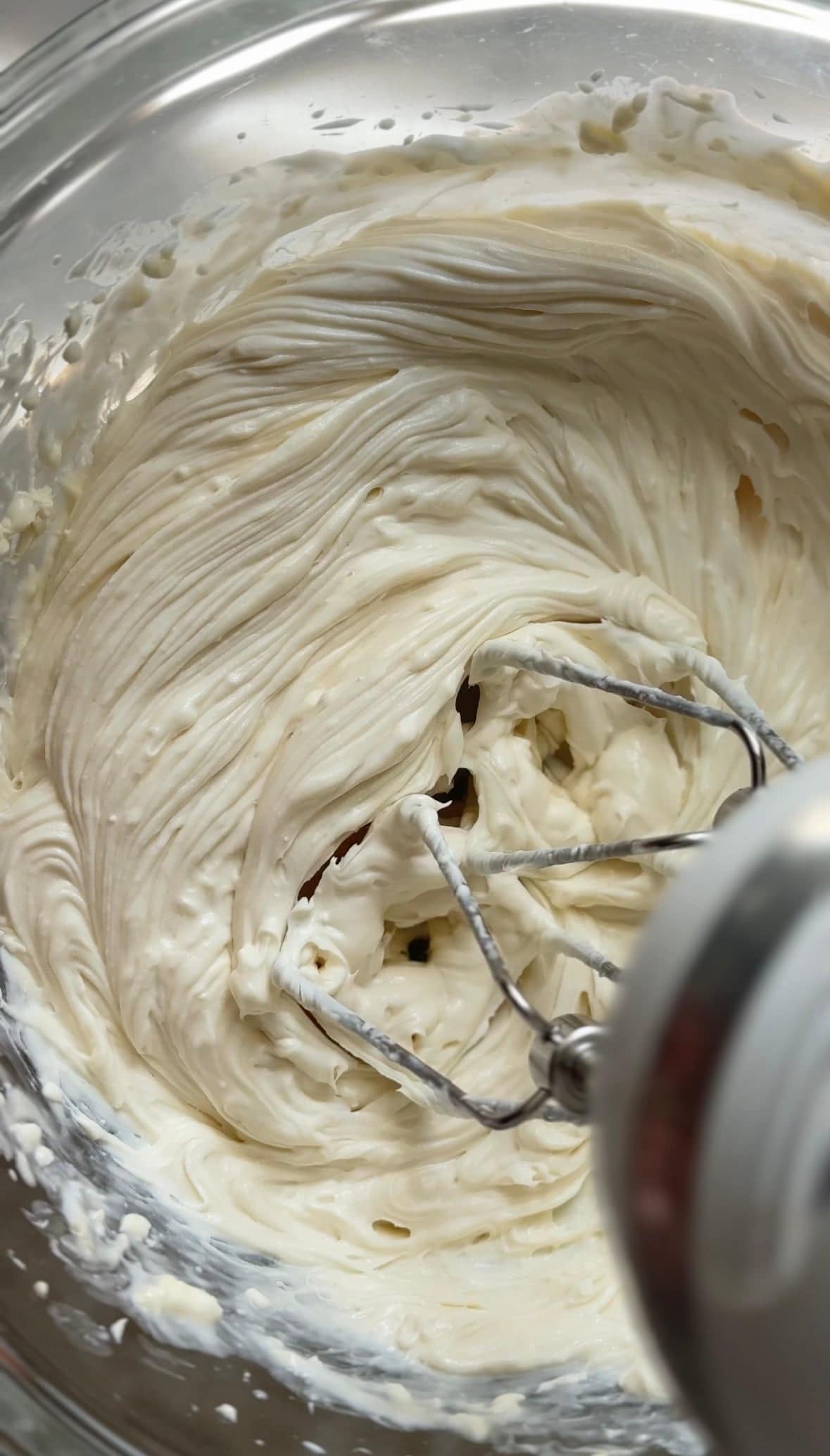 Whip the cream cheese frosting in the bowl with a hand mixer until light and fluffy.