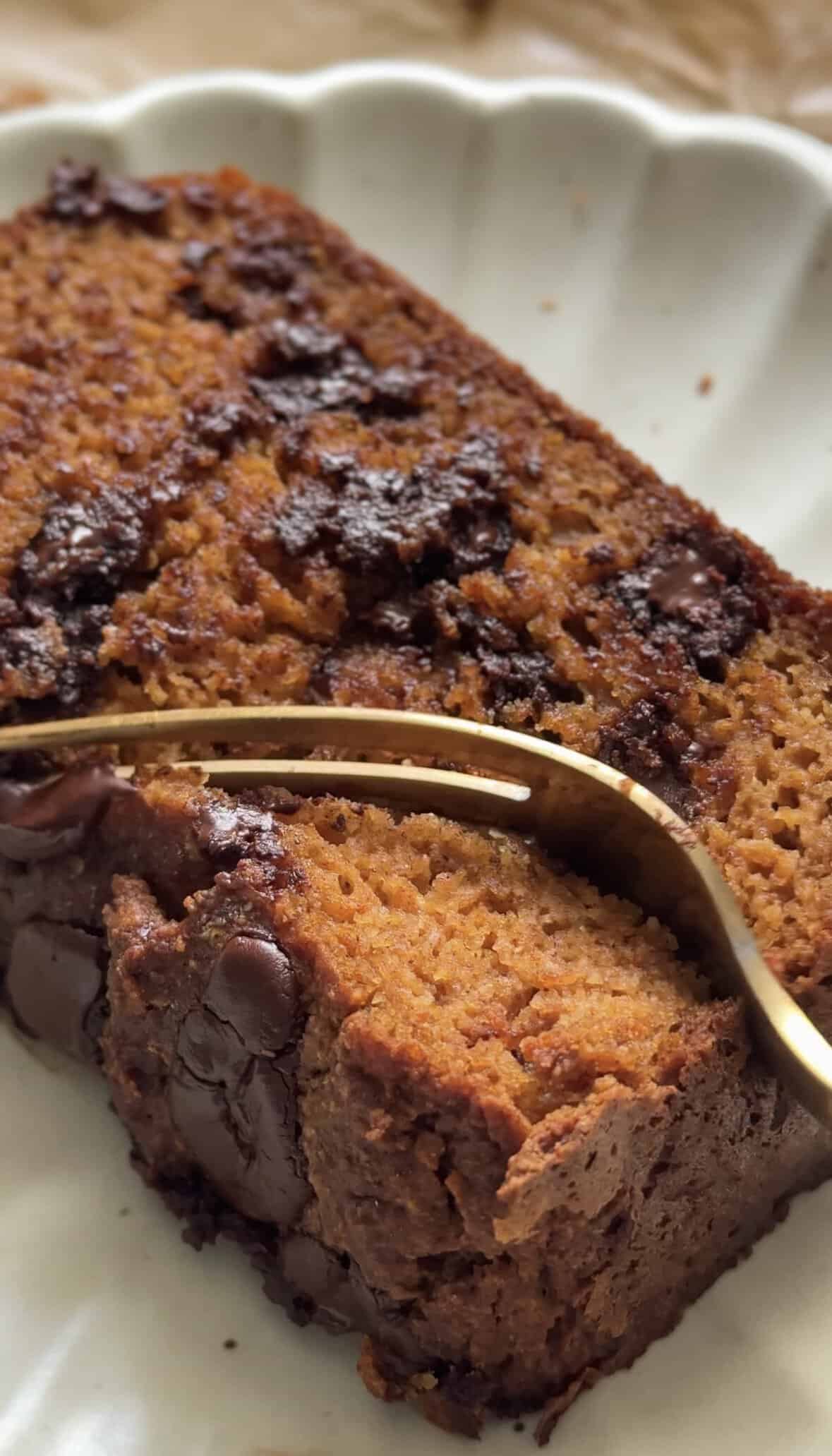 Close up of the Gluten Free Protein Pumpkin Bread slice with a fork on a plate.