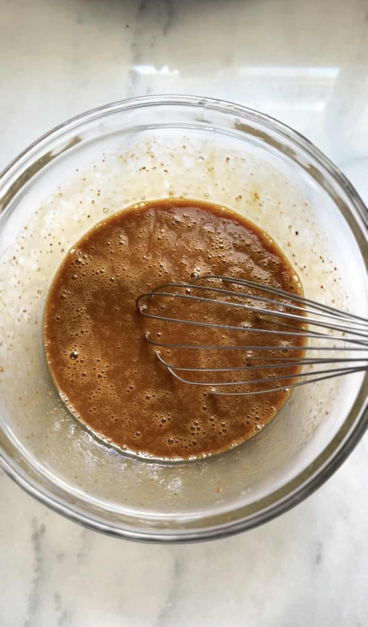 Mixed wet ingredients of the banana donuts in a bowl.