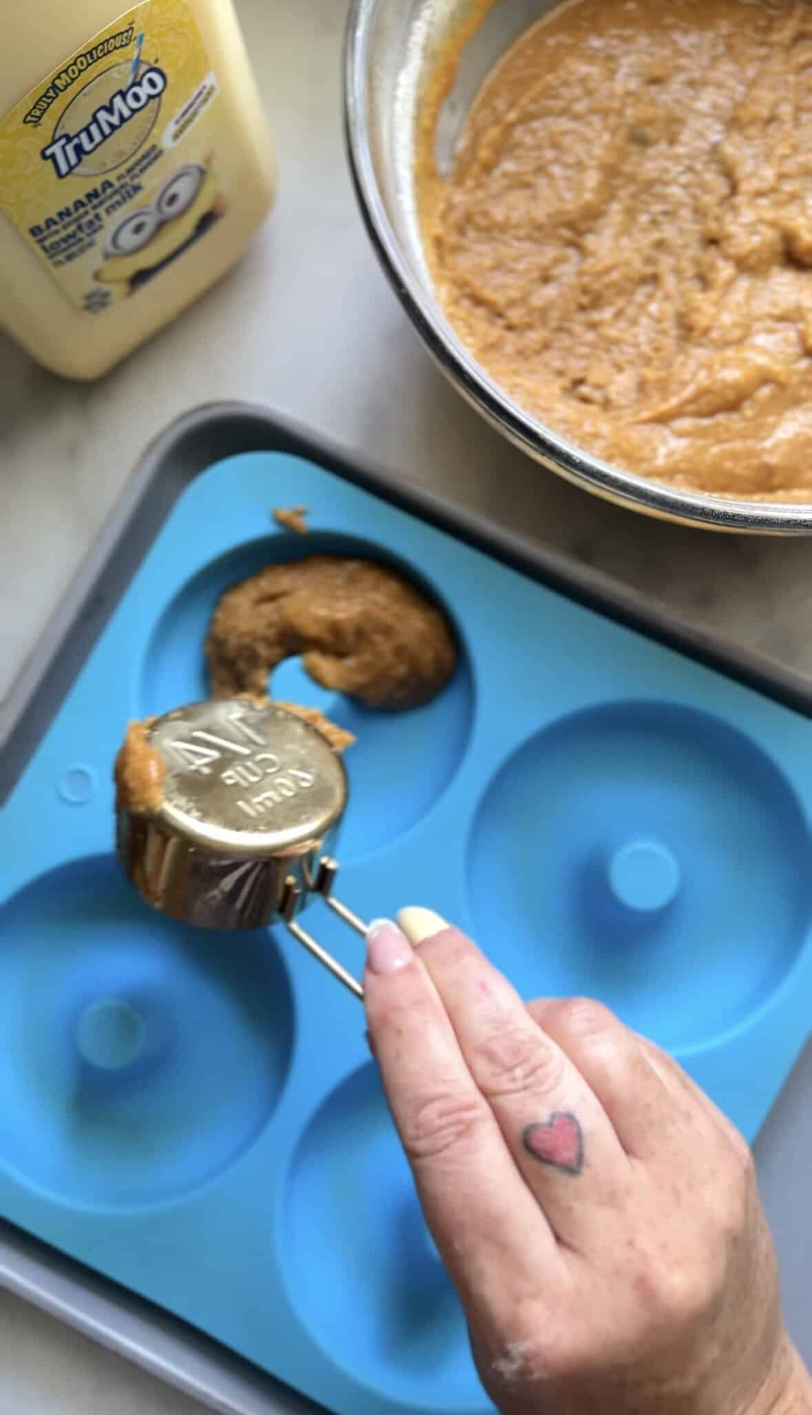 Pour the banana donut batter into the silicone donut mold.