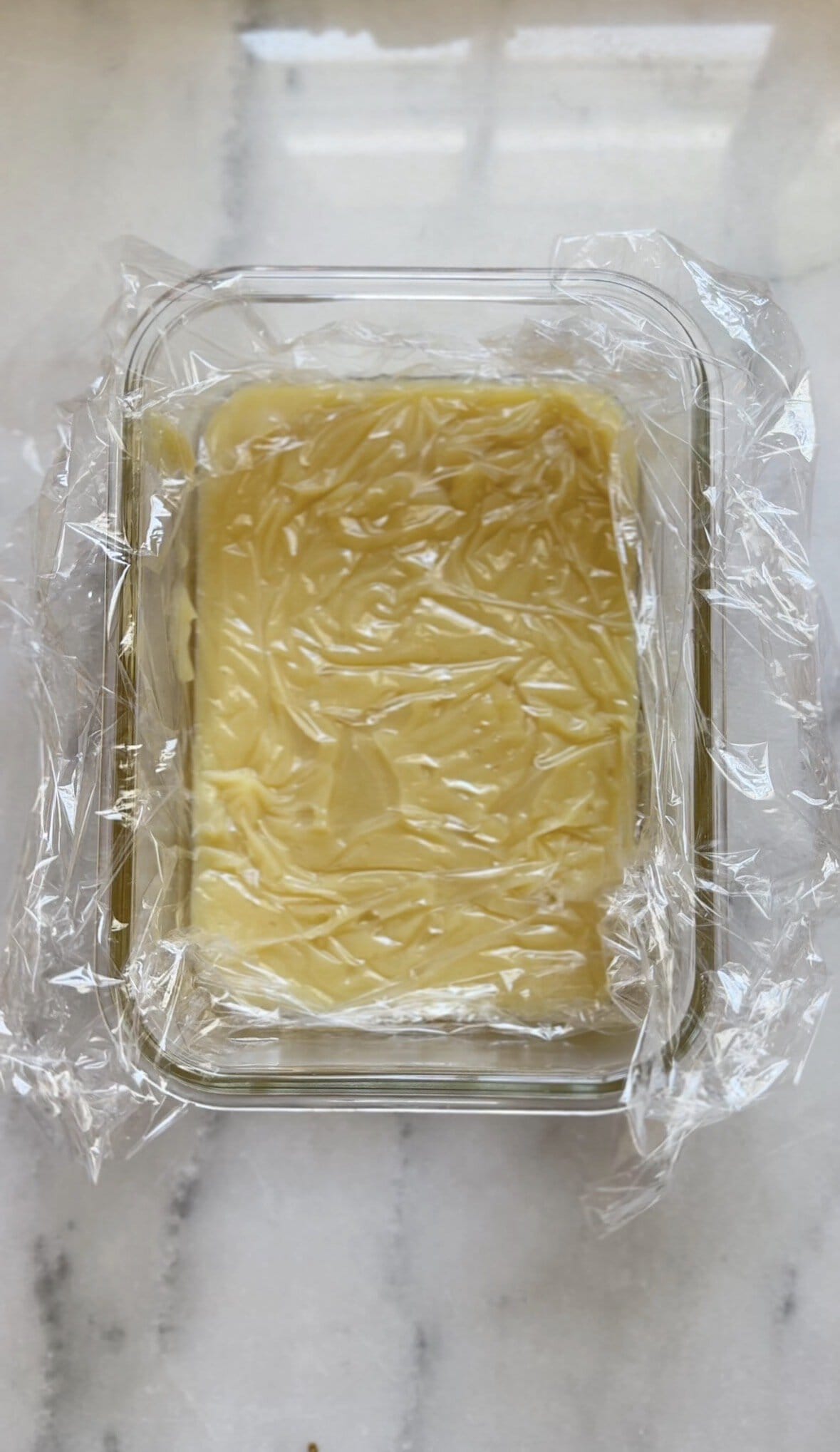 Cover the frosting base in a heat proof container with plastic wrap and cool.