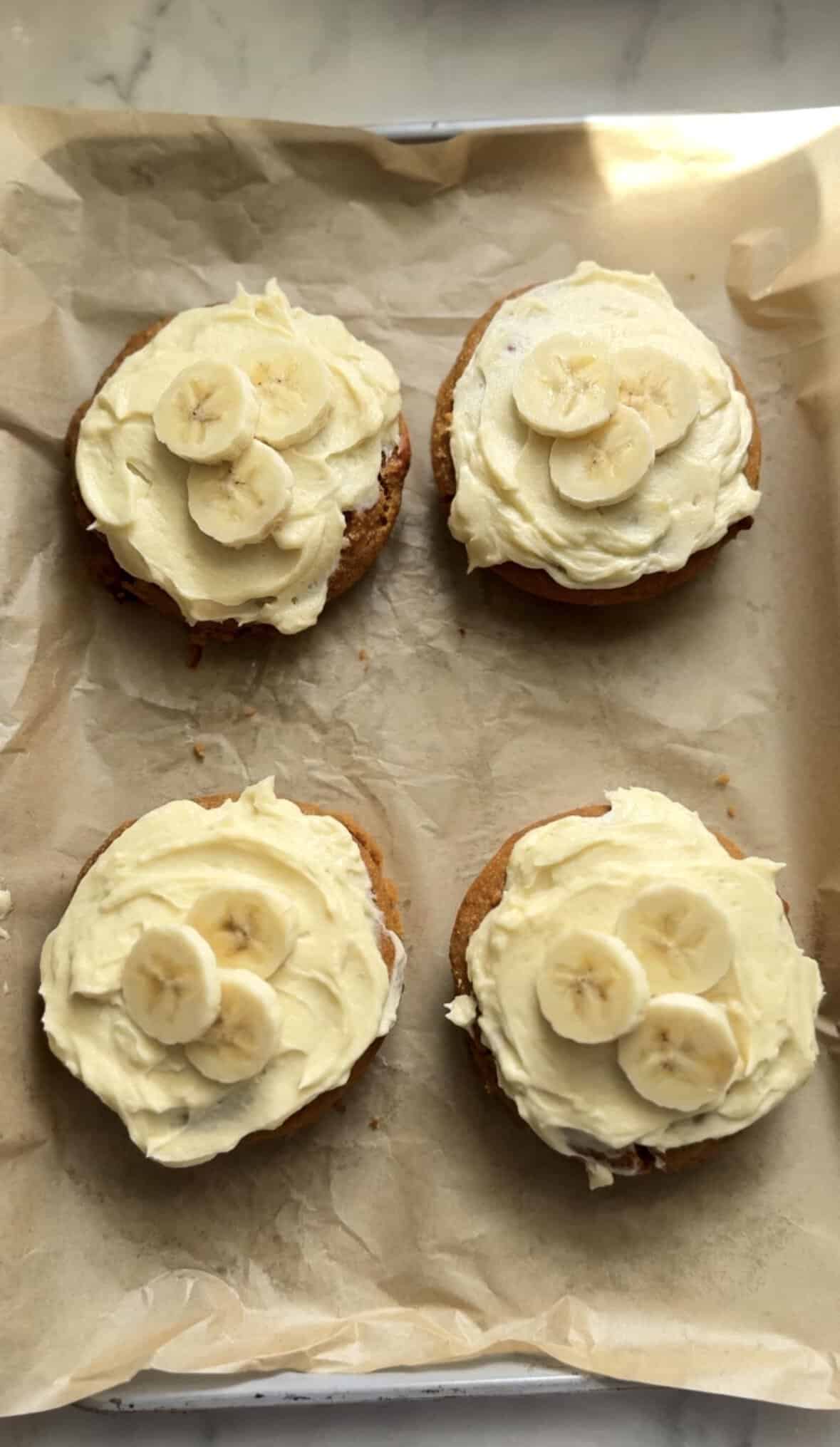 Gluten Free Baked Banana Donuts topped with fresh sliced bananas.