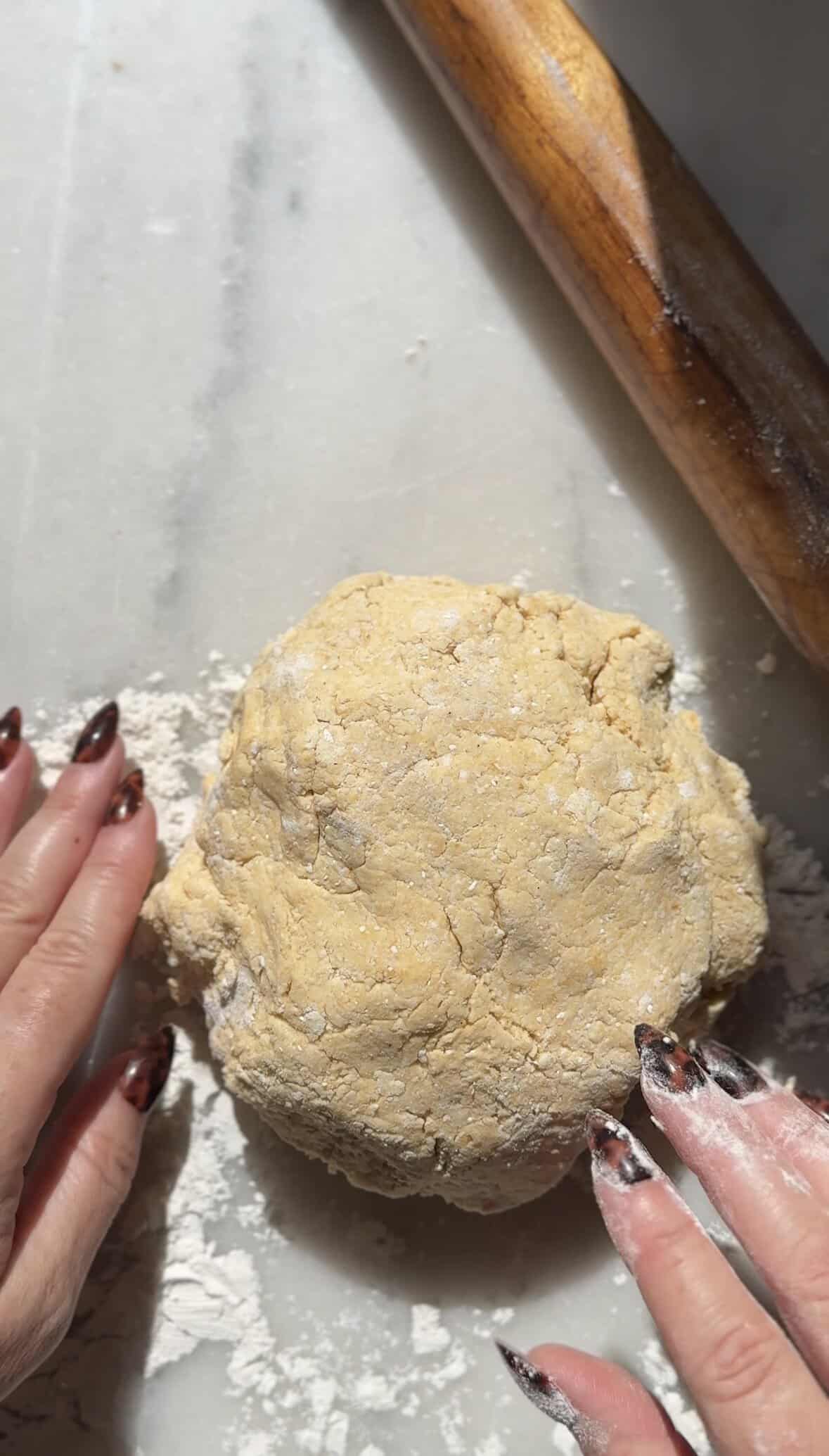 Add the pumpkin cottage cheese cinnamon roll dough on top of the floured countertop.