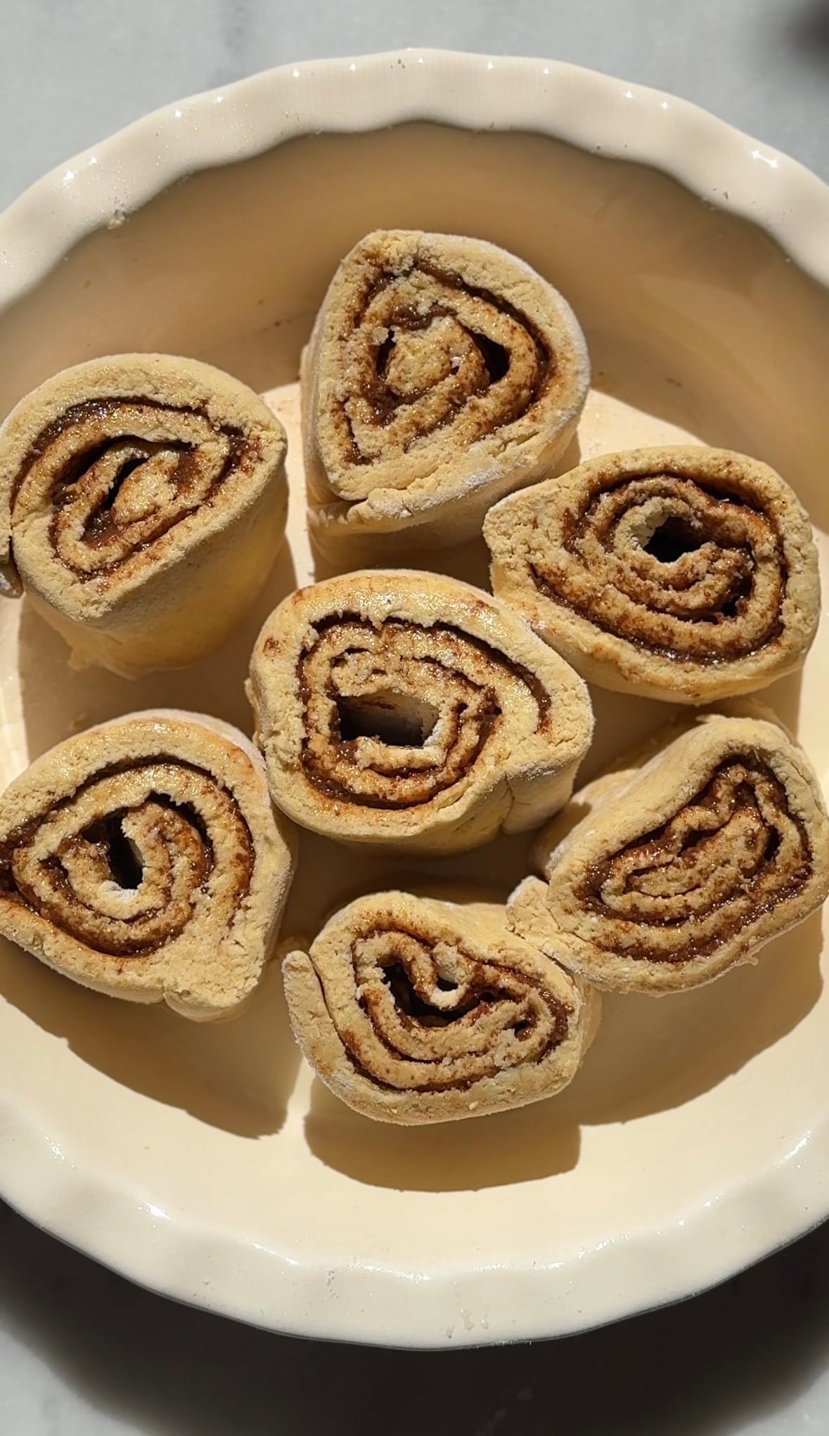 Arrange the cinnamon rolls into a greased baking dish evenly spaced.