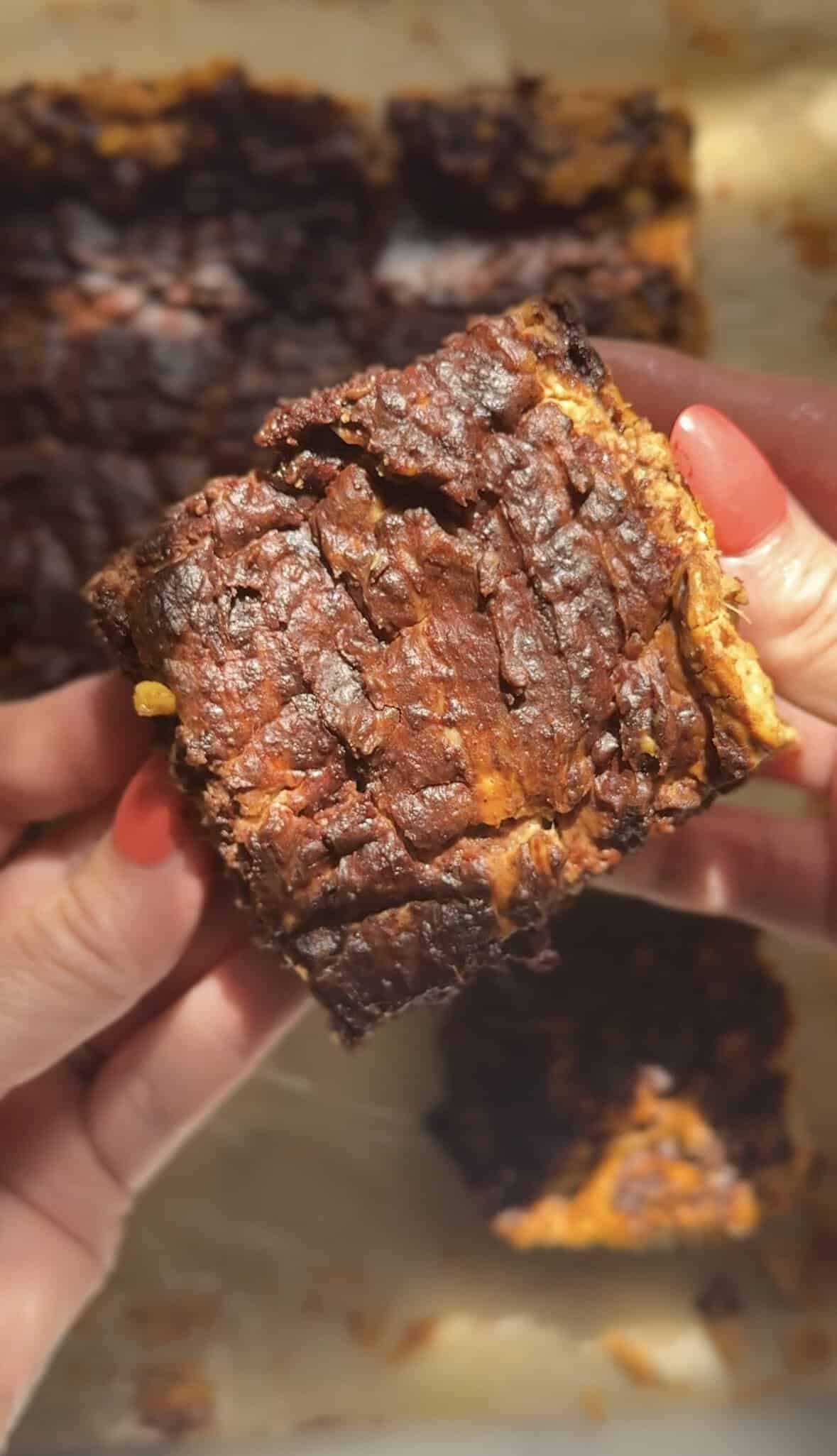 Finished Pumpkin Brownie square being held to show texture from the top.