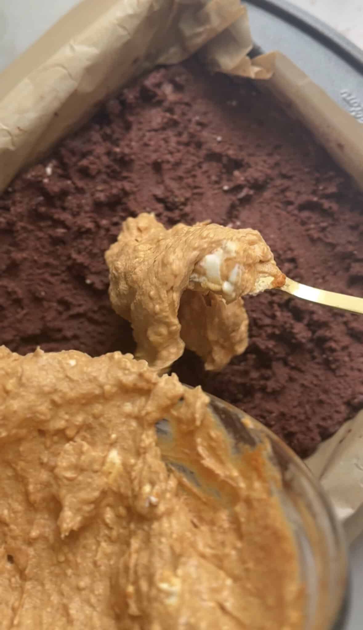 Pour the pumpkin cream cheese on top of the leveled brownie base.