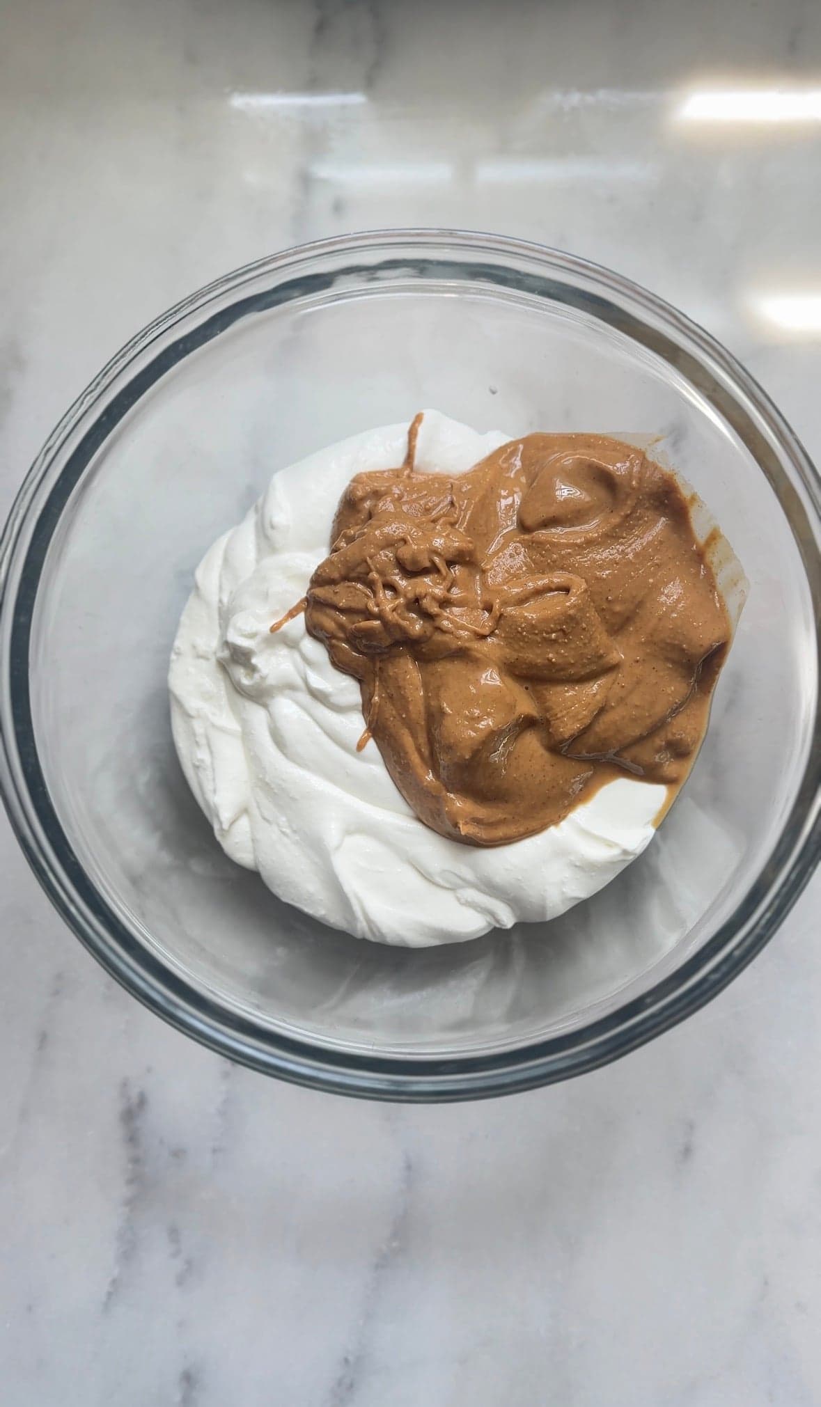 Add whipped cottage cheese and drippy peanut butter into a bowl.