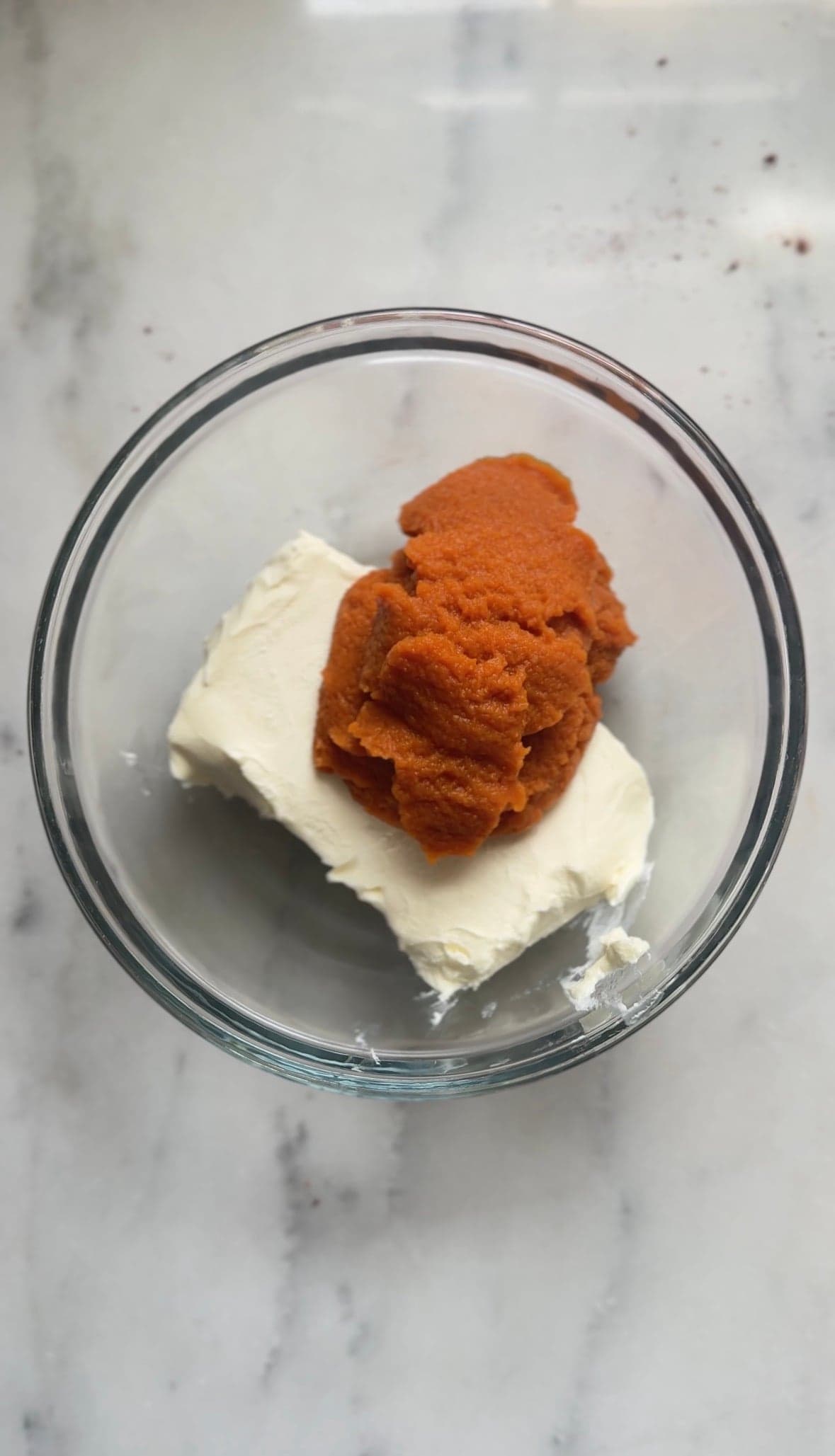 Add cream cheese and pumpkin puree into a bowl.