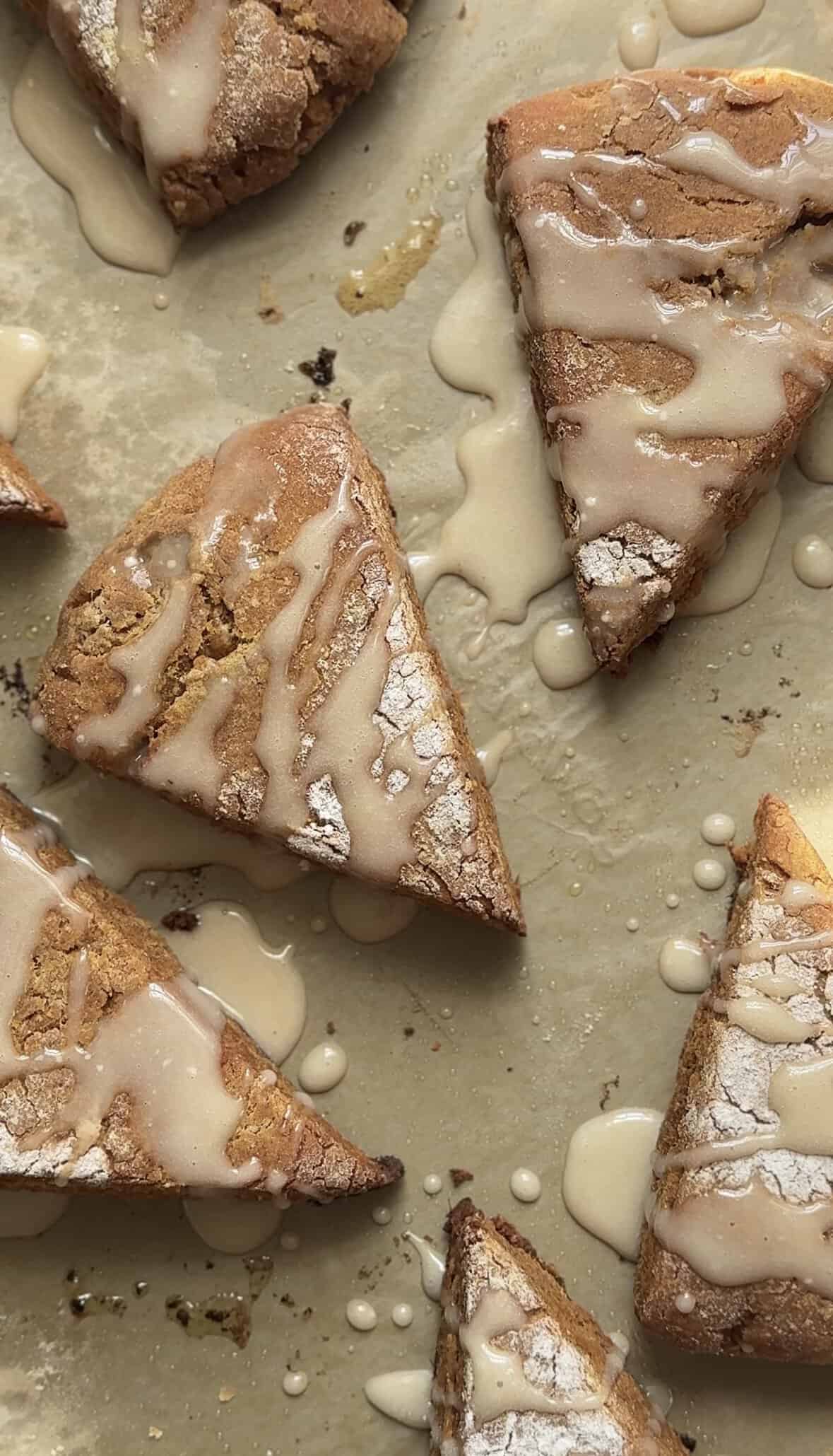 Baked and glazed Pumpkin Cottage Cheese Scones on a sheet pan.