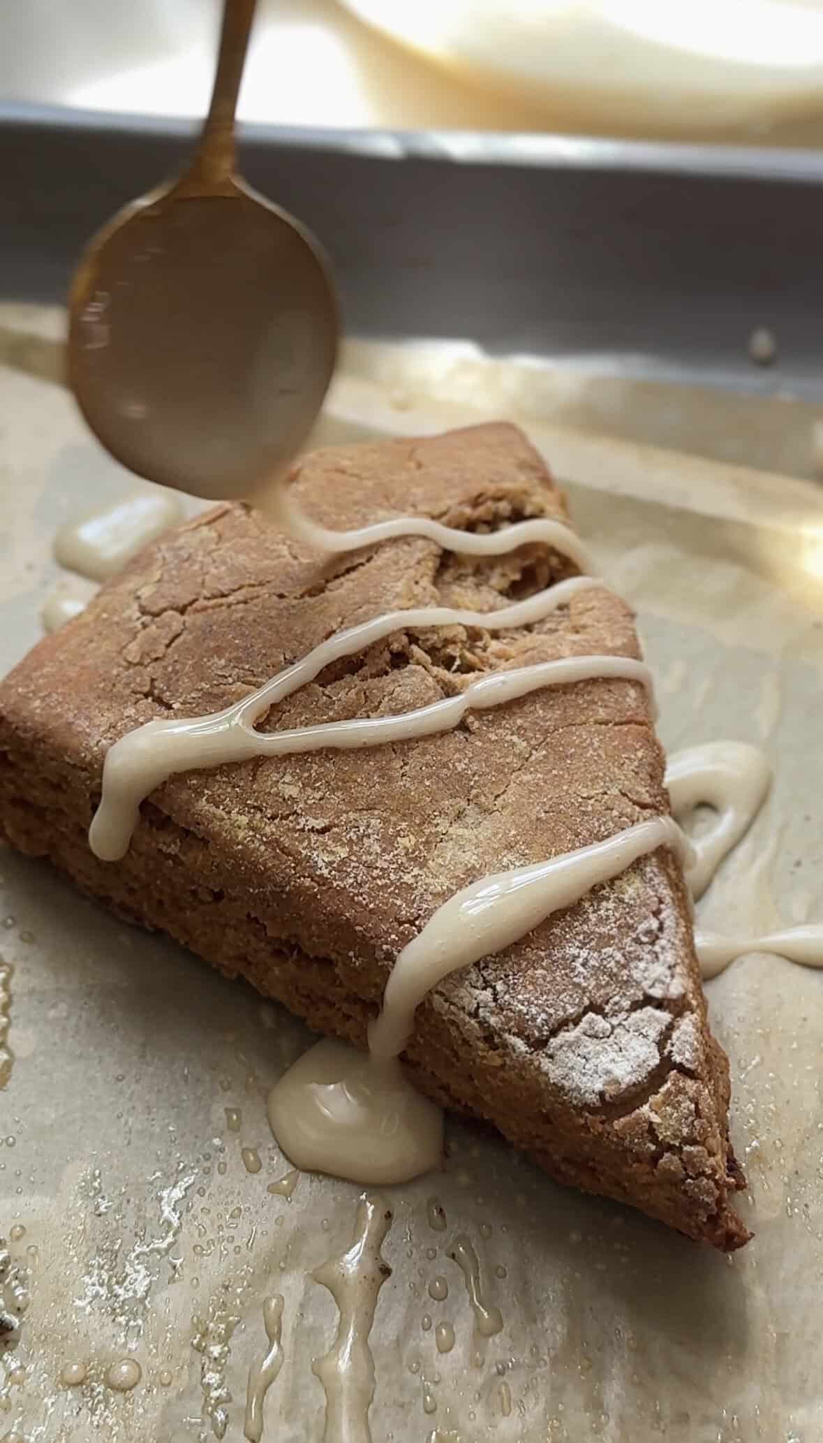 Glazing a Pumpkin Cottage Cheese Scone with a vanilla glaze.