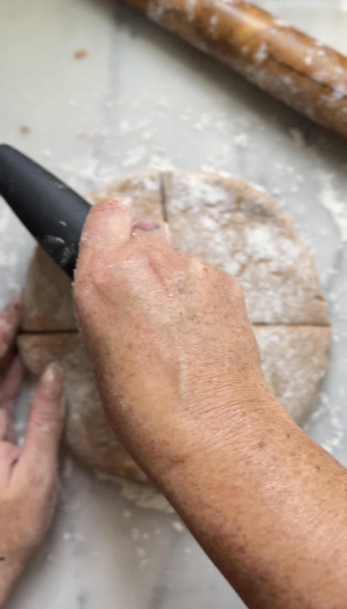 Cutting the Pumpkin Cottage Cheese Scones dough into 8 wedges using a knife or a bench scraper.