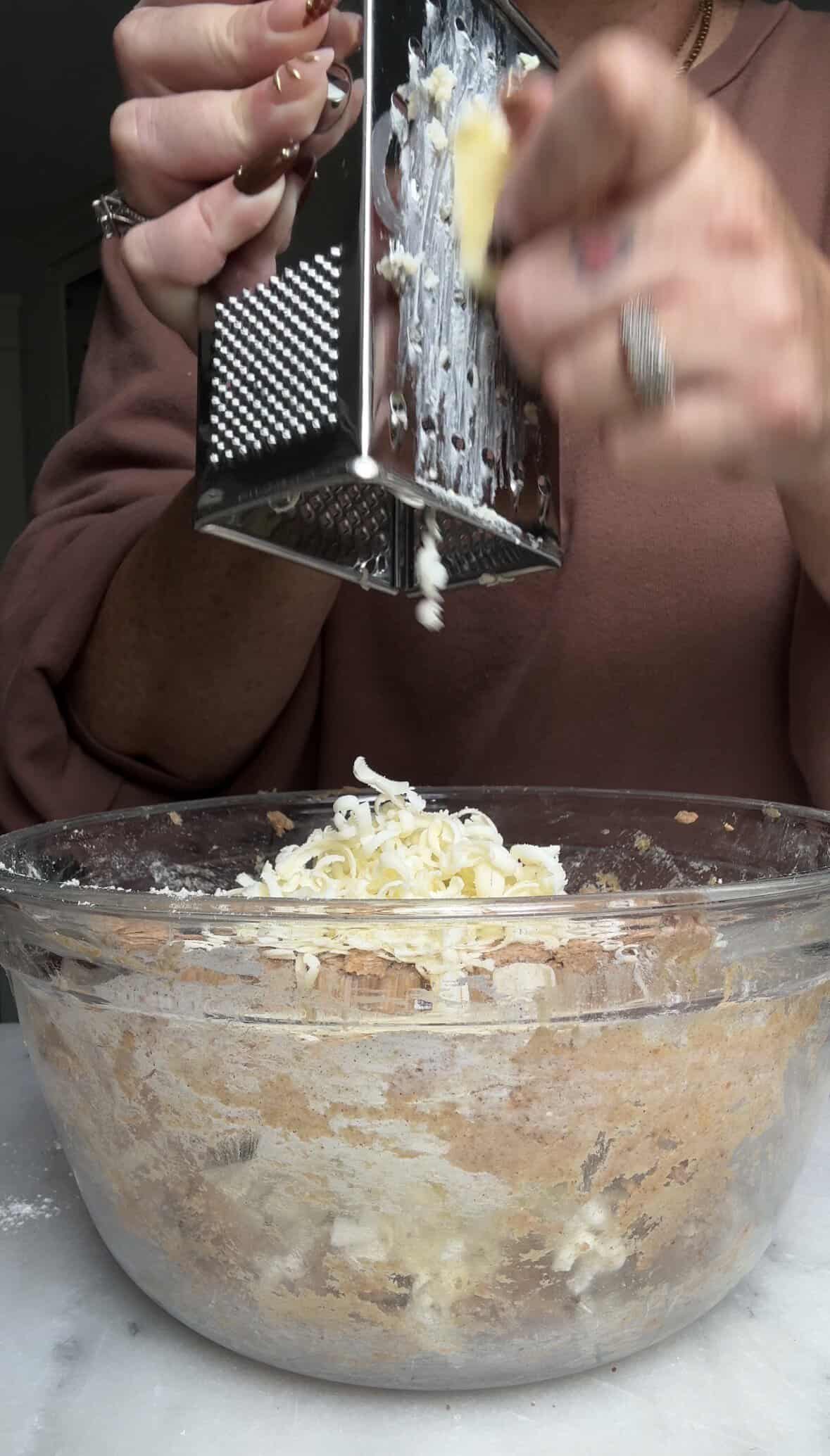 Grate frozen butter into the Pumpkin Cottage Cheese Scone dough.