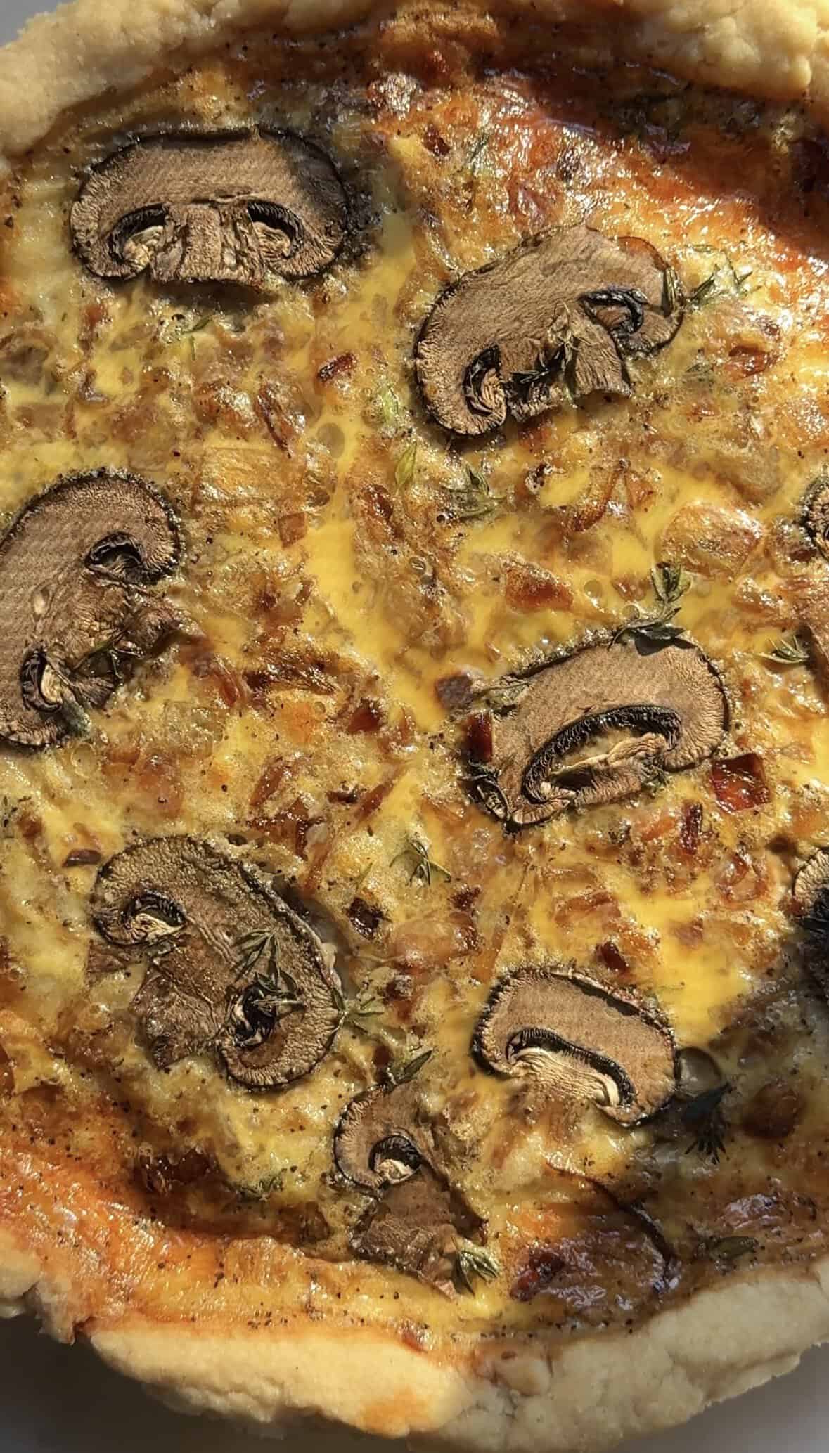 Close up of the baked Gluten Free Caramelized Onion Quiche in the pie tin.