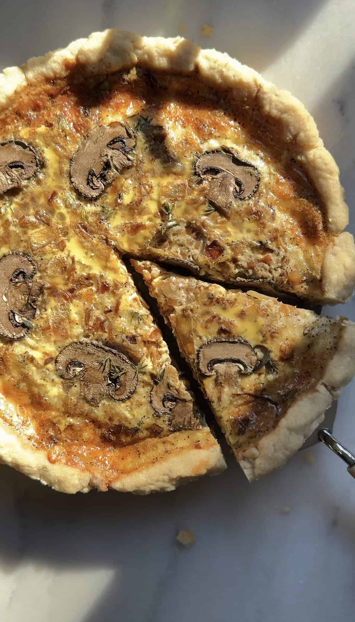 Gluten Free Caramelized Onion Quiche with a slice being taken out with a pie spatula.