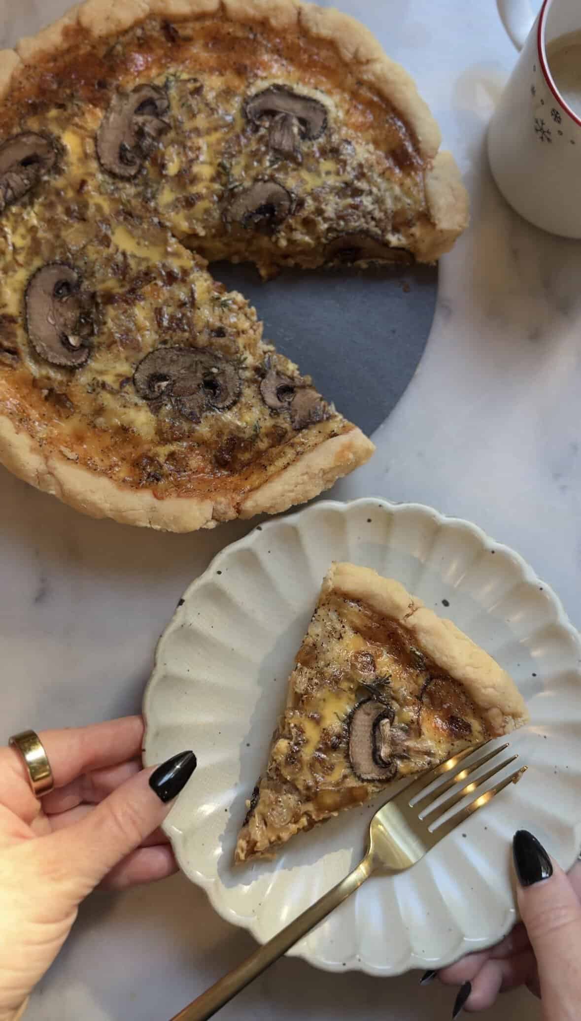 Gluten Free Caramelized Onion Quiche slice on a plate with a fork.