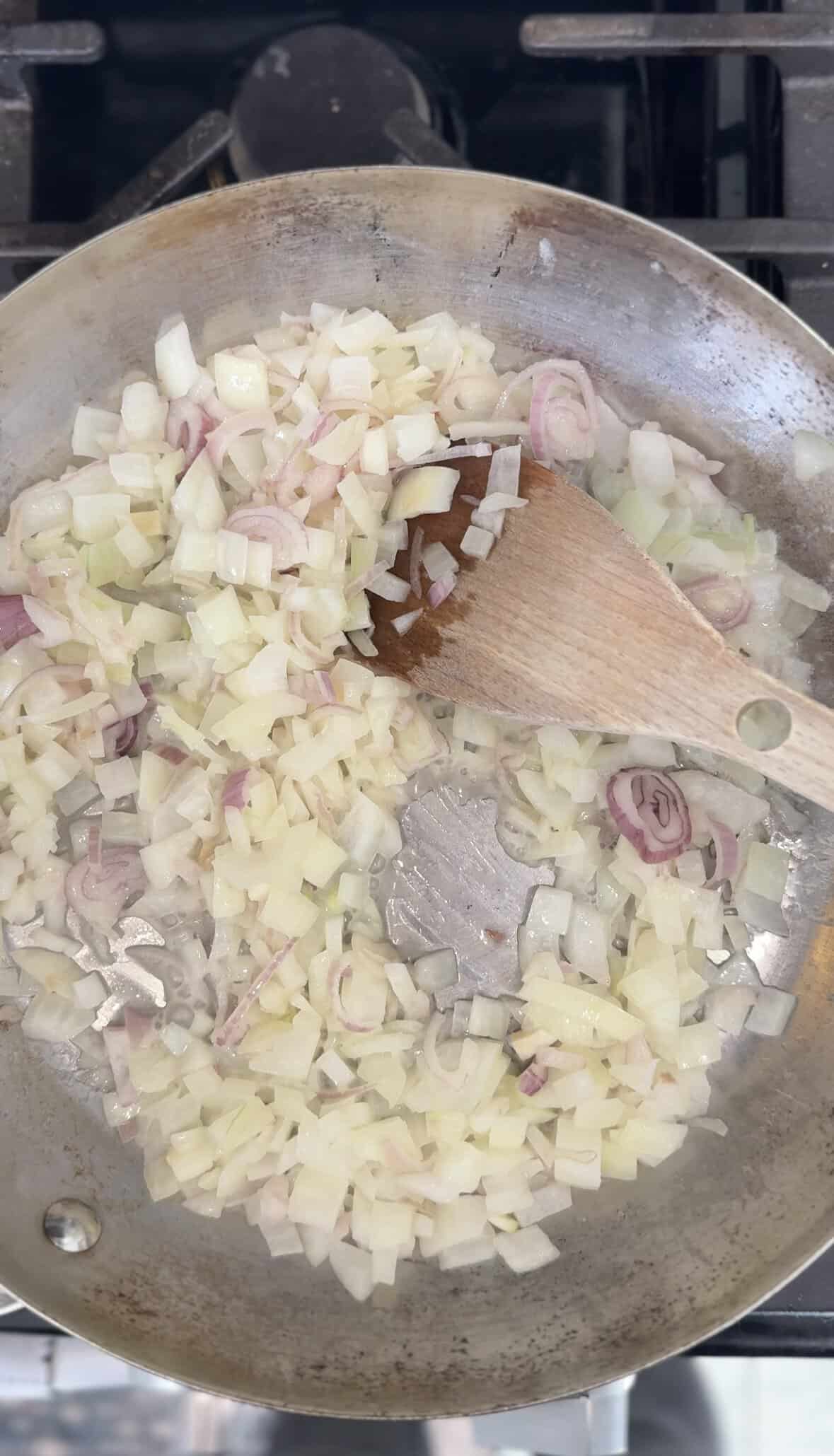 Start cooking down the onion and shallot in the skillet with the butter.