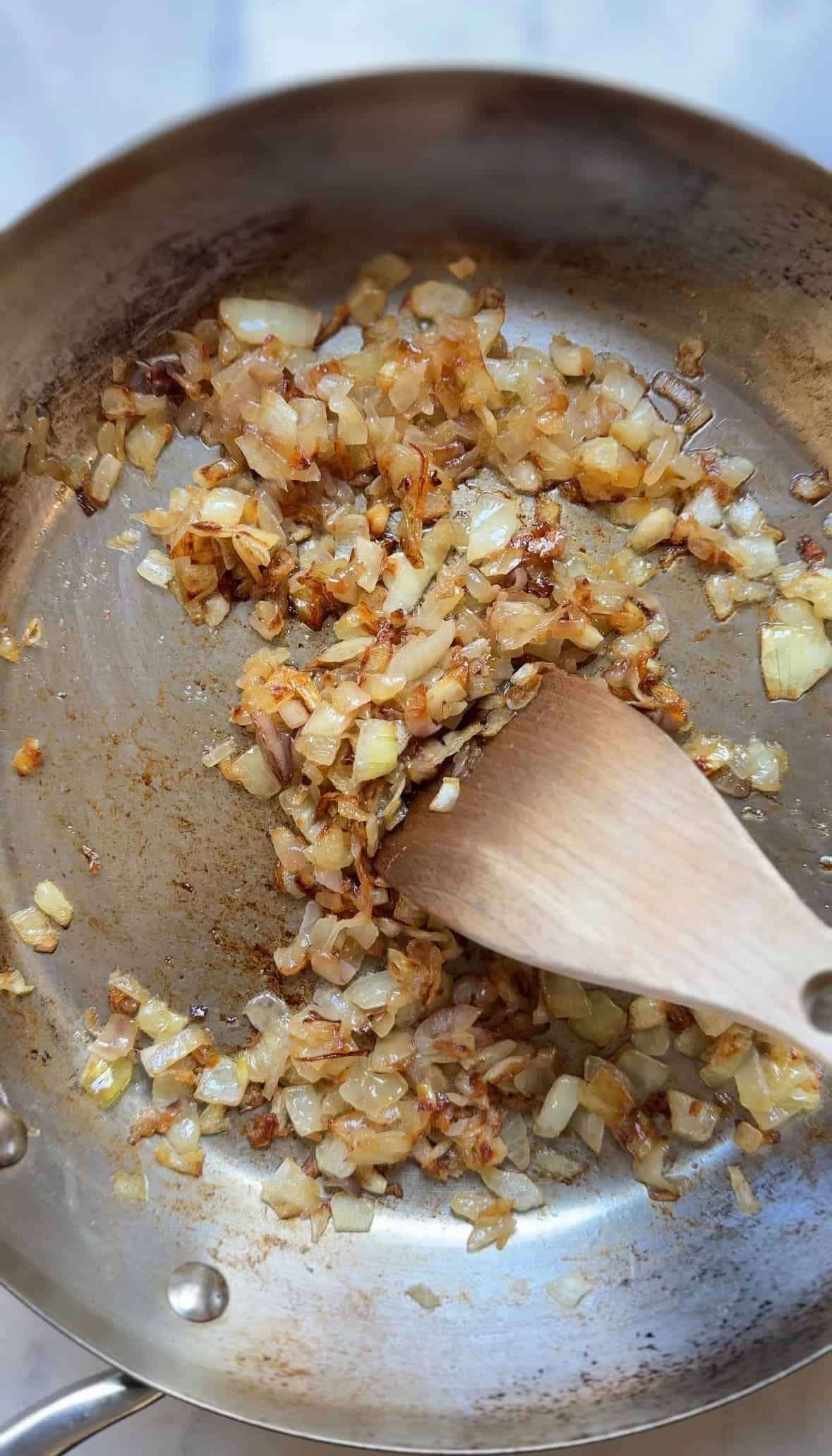 Caramelize the onion and shallot in the skillet with the butter.