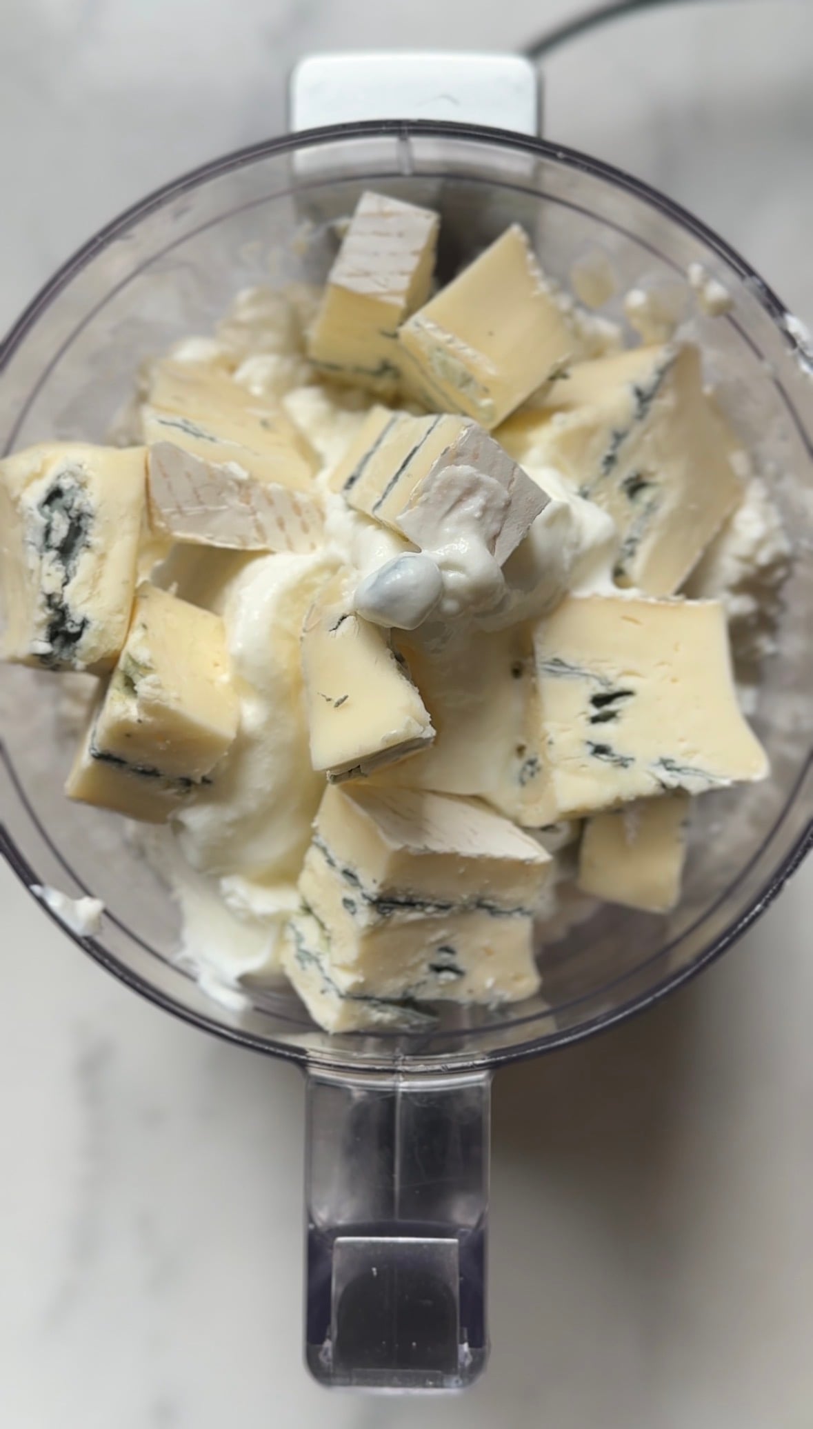 Add blue cheese to the food processor.