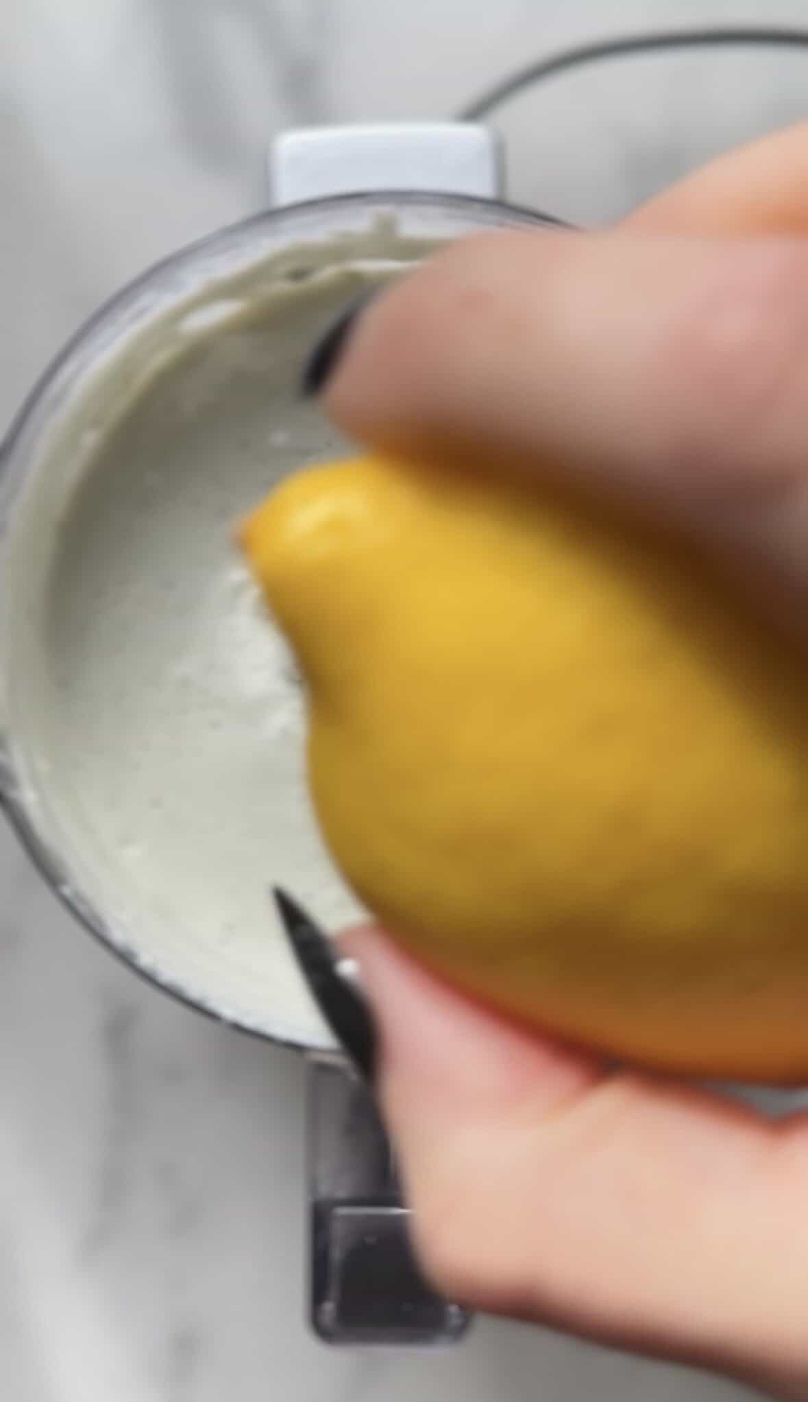 Add the lemon juice into the food processor with the blended dirty martini dip base.