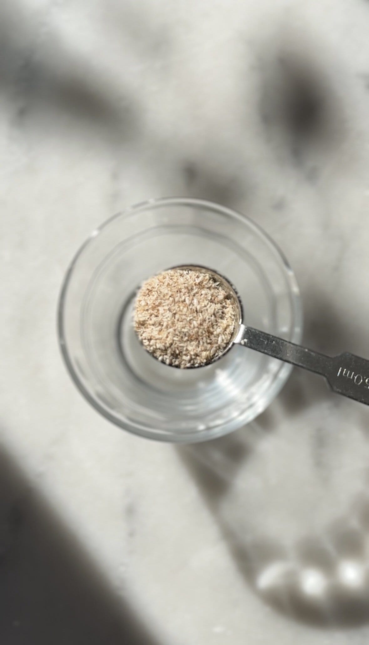 Measuring the psyllium husk into a small bowl.