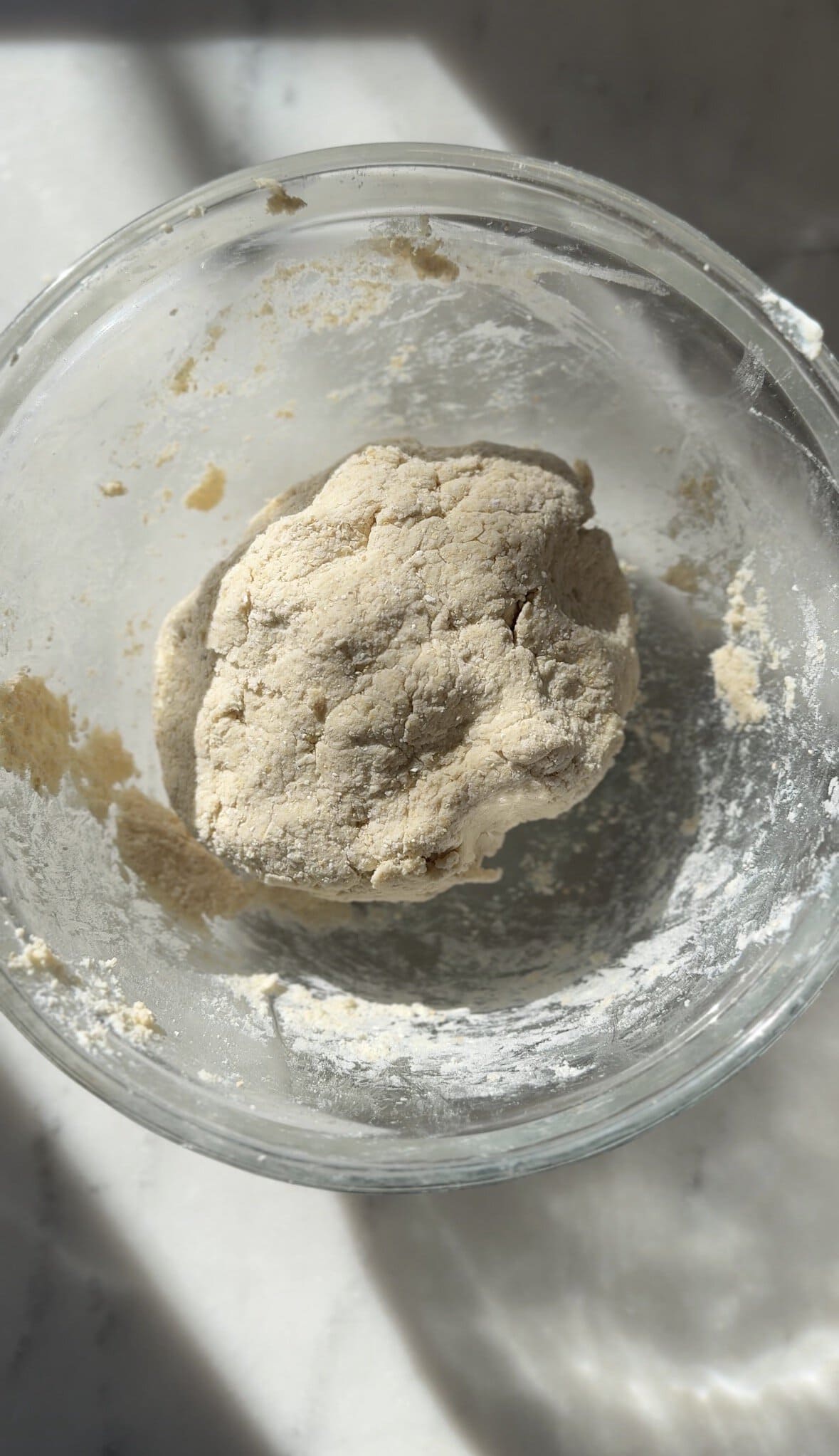 gluten-free cinnamon roll dough in a bowl resting for 10-15 minutes before rolling out.