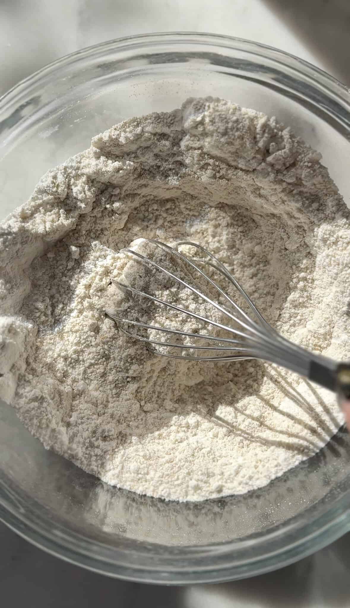 Mixed dry ingredients of the gluten-free cinnamon rolls in a bowl.