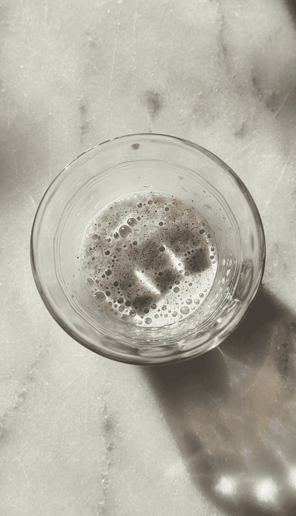 Small bowl of the psyllium husk and milk mixture being hydrated to use in the gluten-free cinnamon rolls.