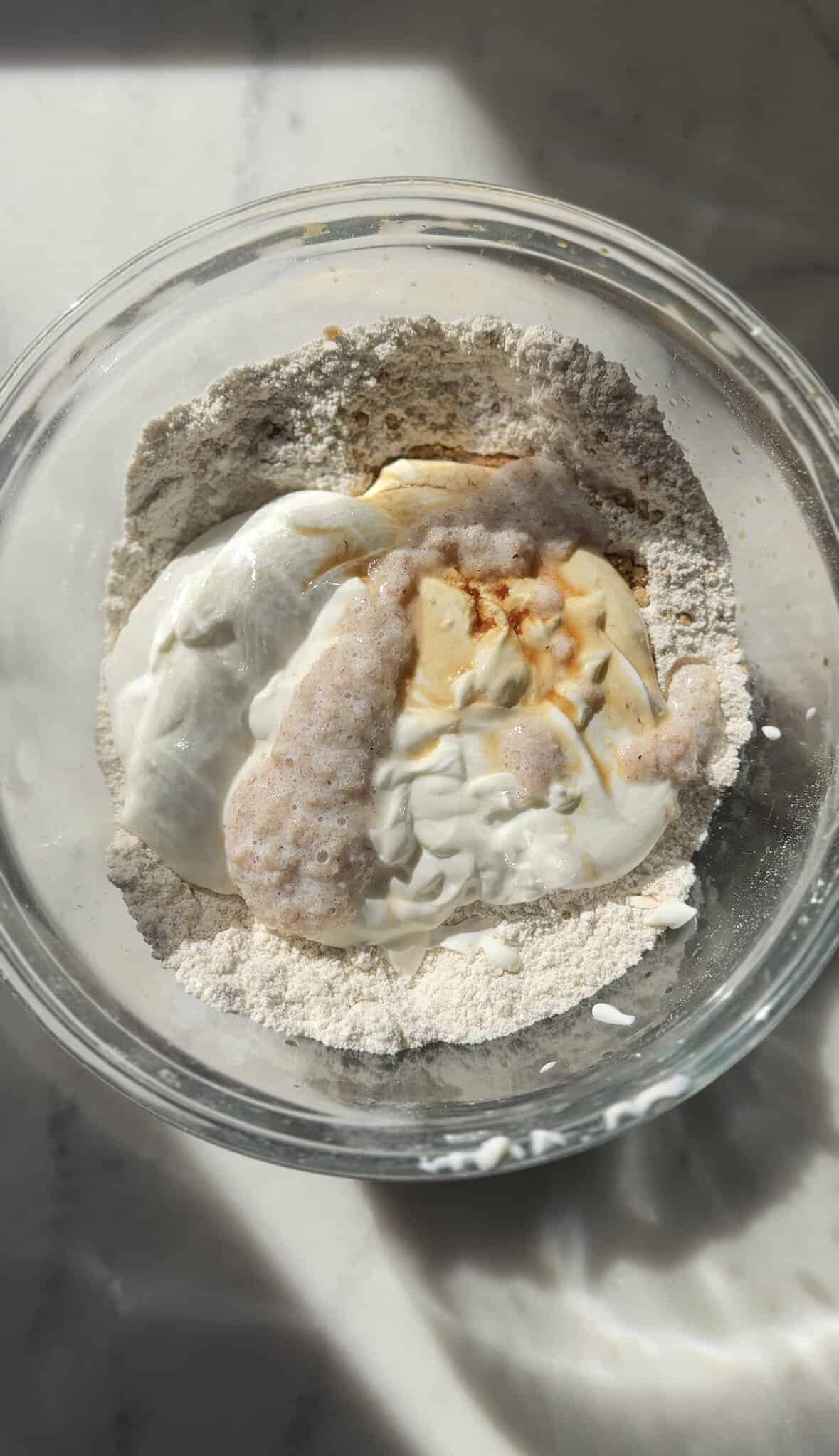 Add psyllium husk to the gluten-free cinnamon roll dough in the bowl.