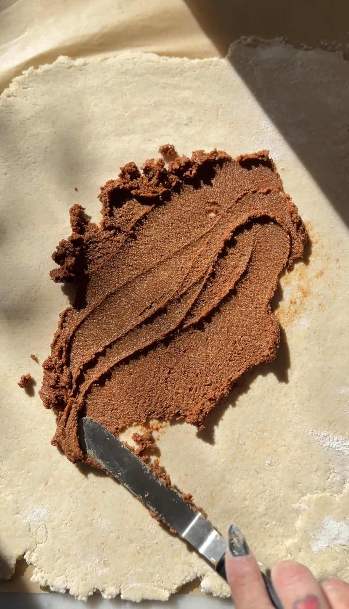 Spread the cinnamon sugar filling onto the rolled out cinnamon roll dough.