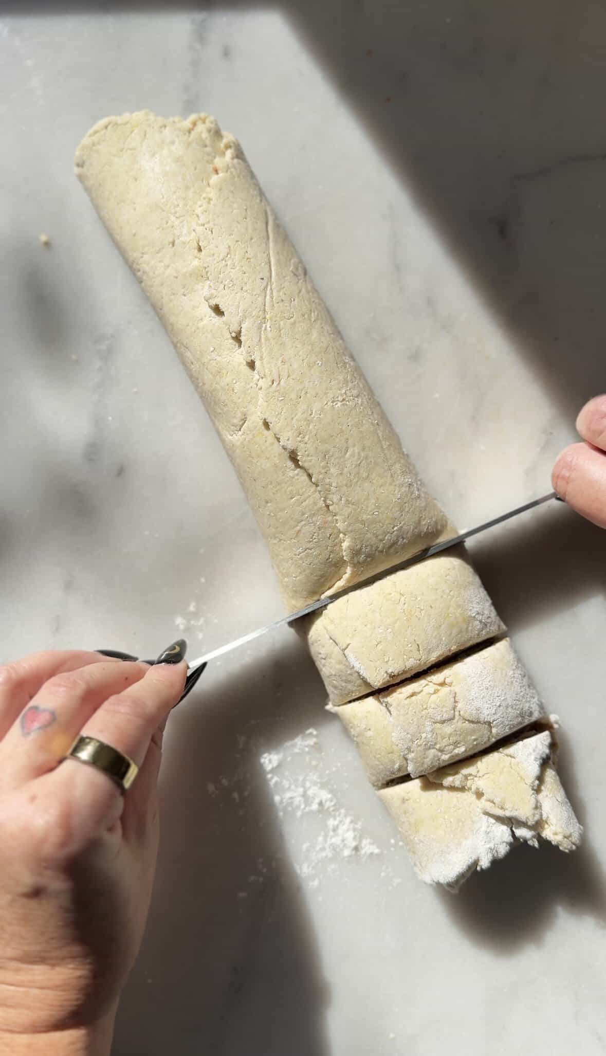 Cut the gluten-free cinnamon roll dough into individual cinnamon roll pieces.