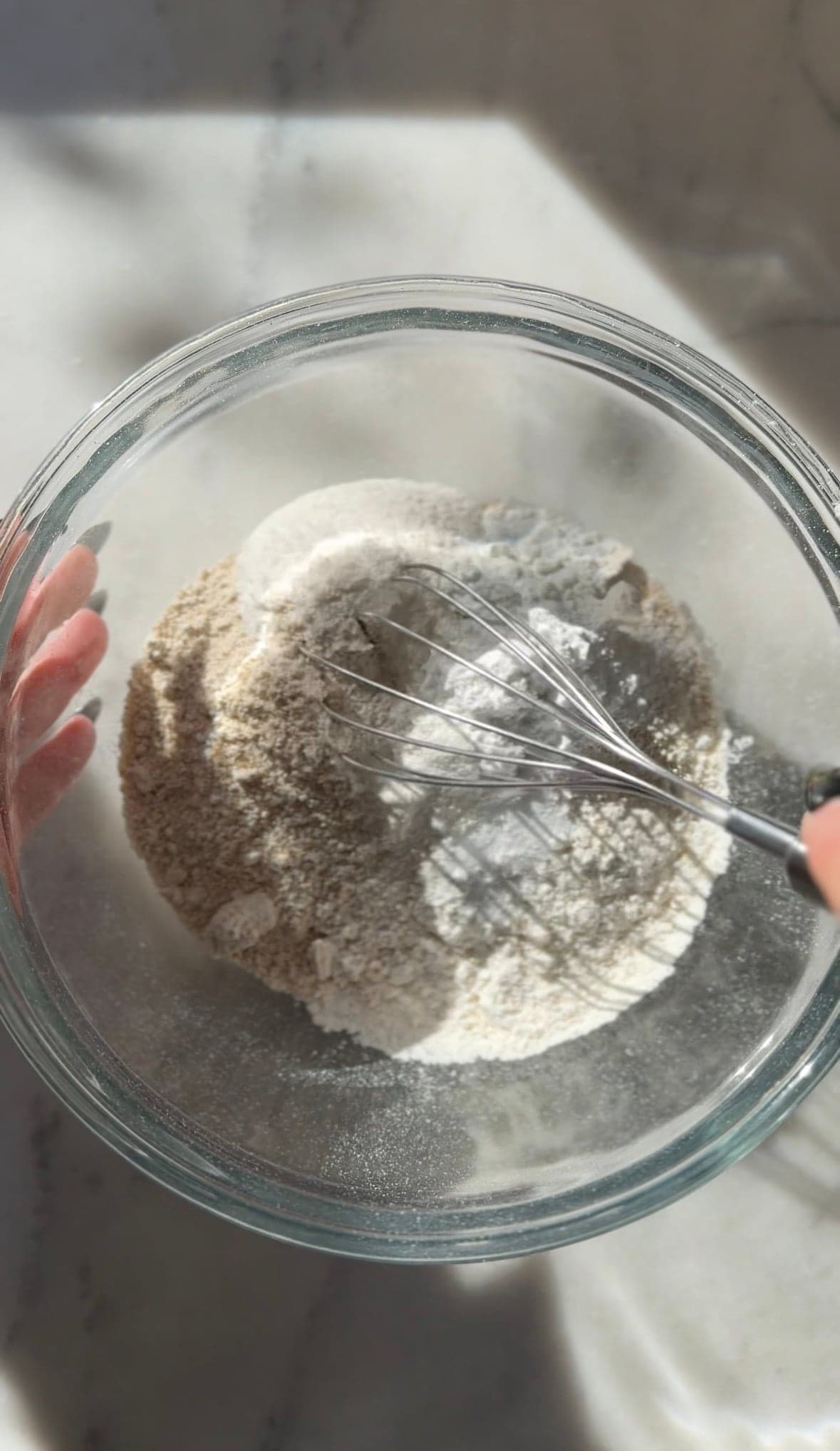 Mixing the dry ingredients of the gluten-free cinnamon rolls in a bowl.