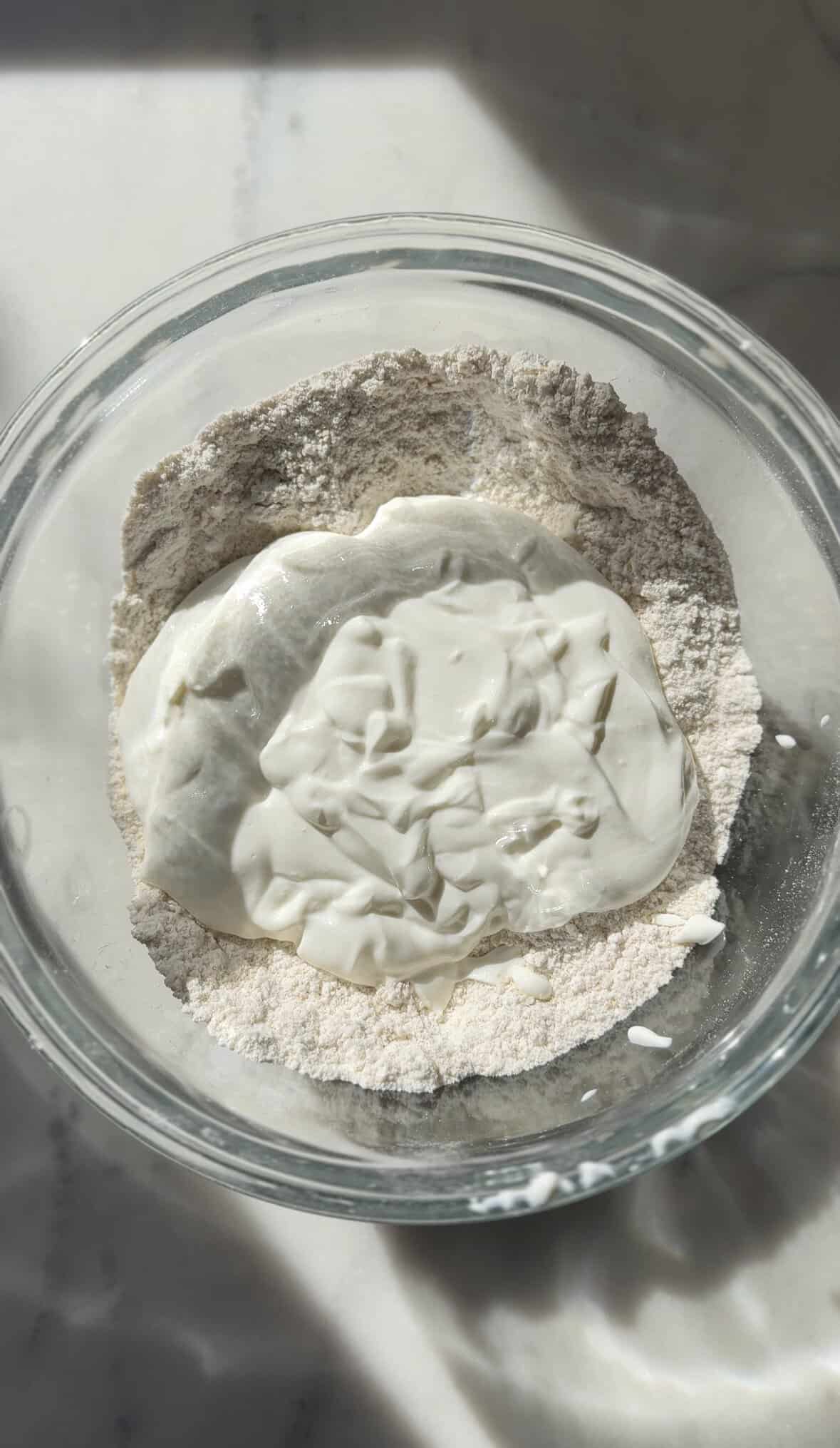 Add the blended cottage cheese to the dry ingredients of the gluten-free cinnamon roll dough.