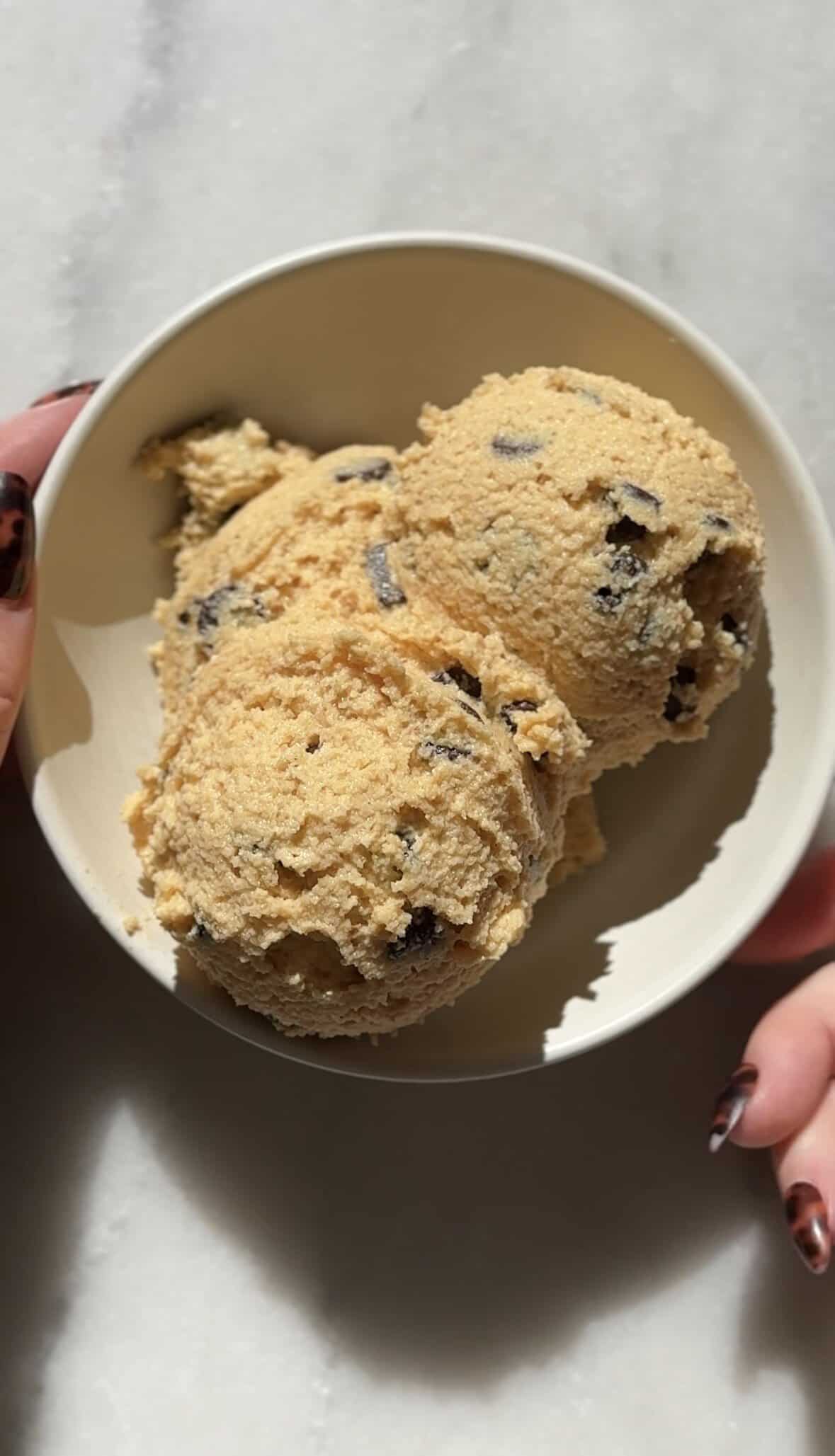 One serving of scooped Pumpkin Cottage Cheese Cookie Dough in a bowl.