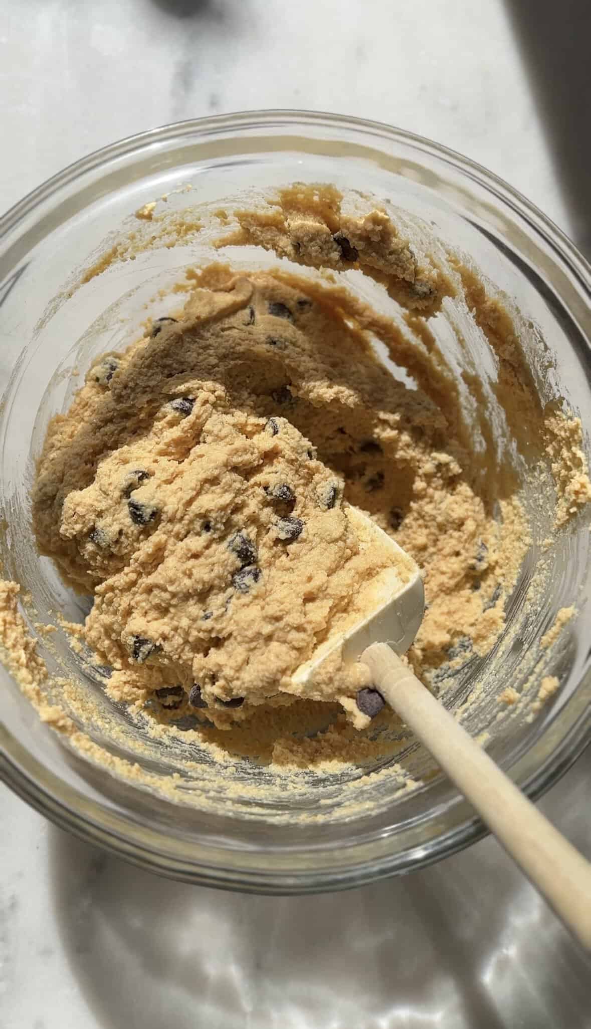 Fold in the chocolate chips with the Pumpkin Cottage Cheese Cookie Dough in the bowl with a rubber spatula.